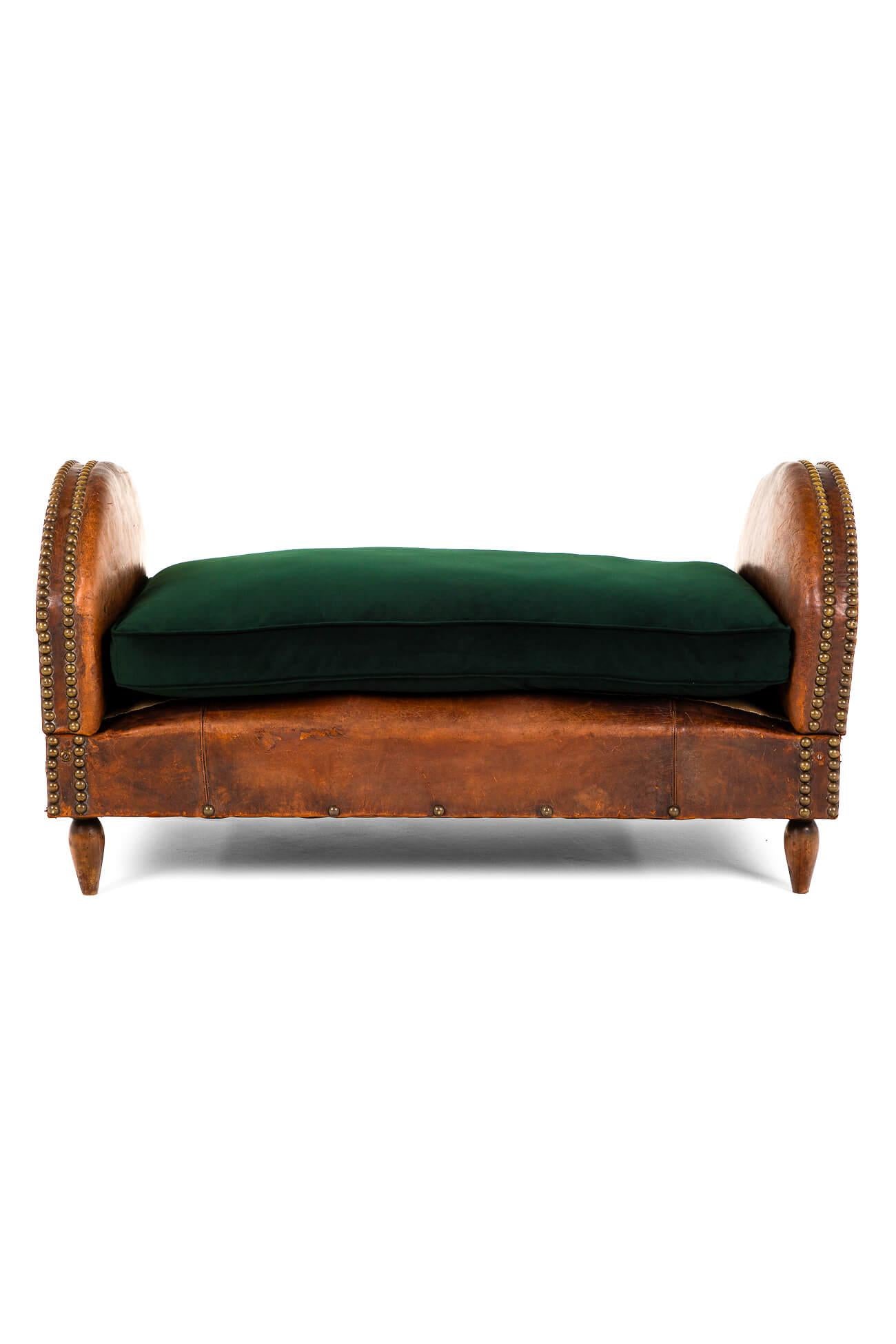 An exceptional fully reclinable brass studded daybed in a rich brown cognac leather.

The daybed has two extendable arms, with four adjustable gradients for each arm. The daybed can be placed into a fully flat position for comfort with semi circular