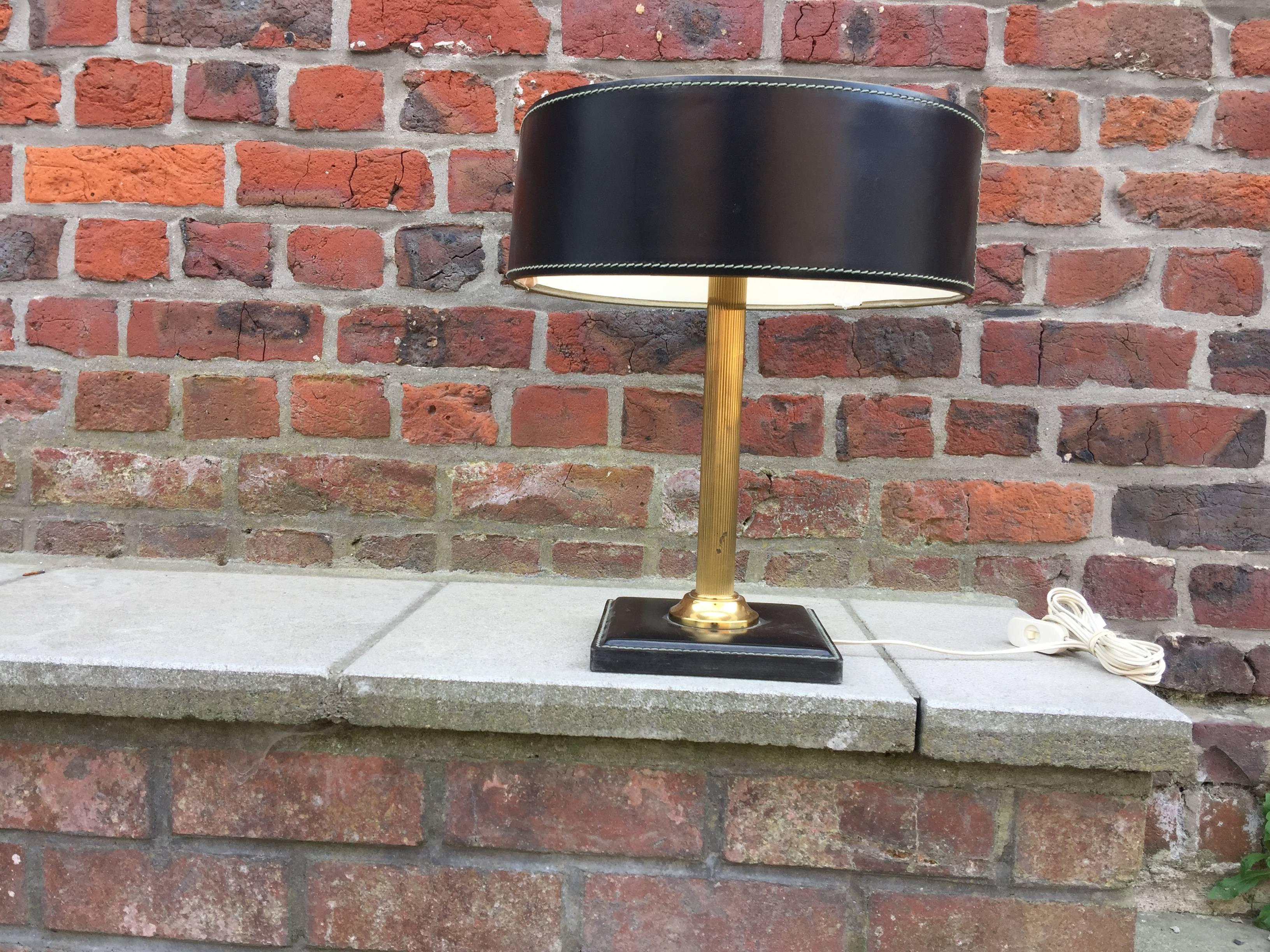 Leather and brass table lamp attributed to Adnet, circa 1950.