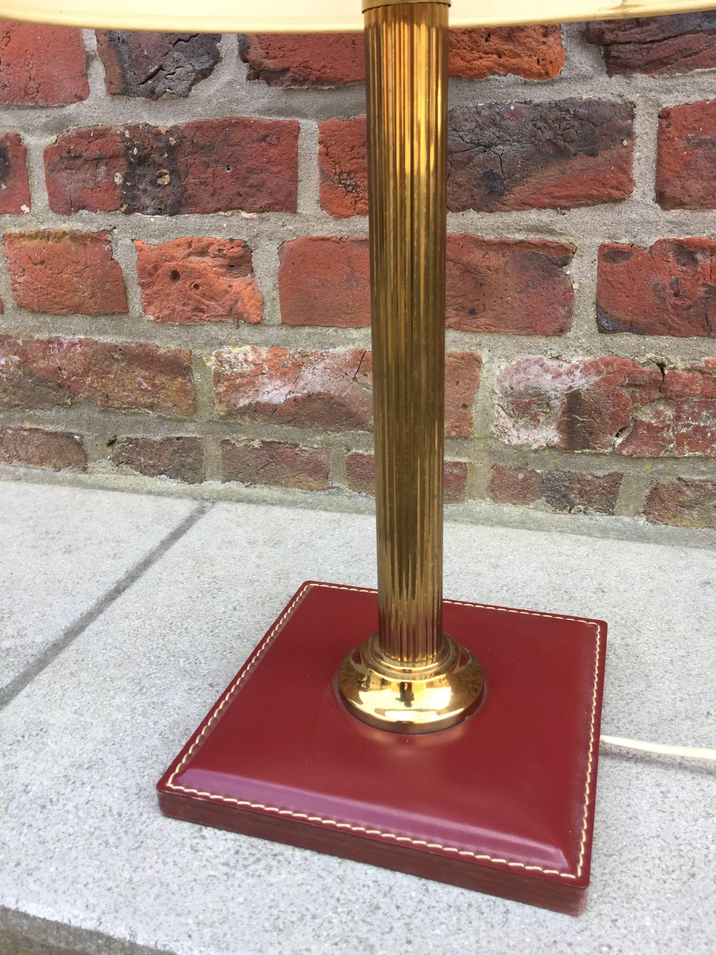 Leather and brass table lamp attributed to Adnet, circa 1950.