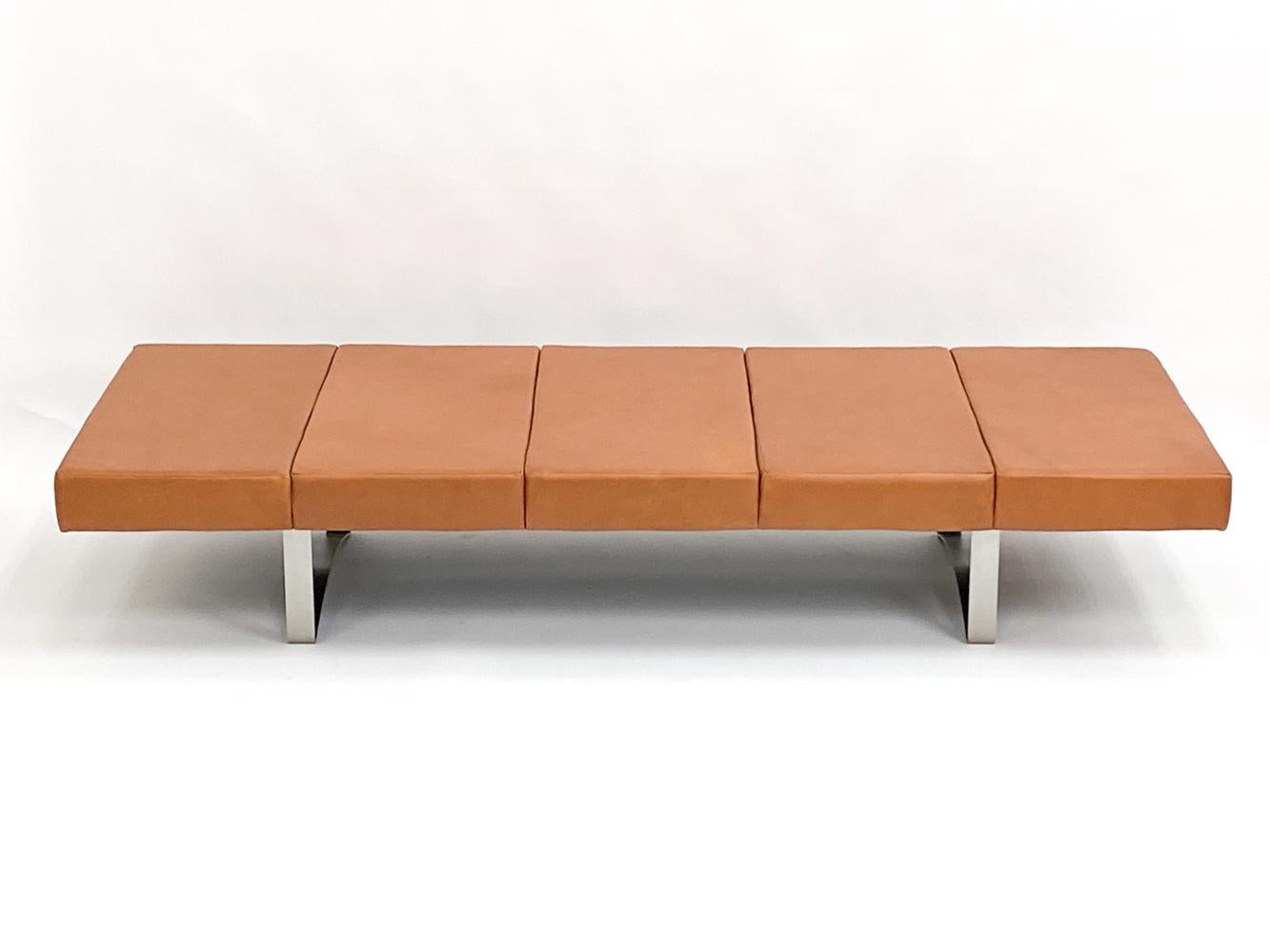 This stylish daybed was designed by Danish maker Bodil Kjaer for manufacturer Illums Bolighus. The original tag is affixed underneath the piece, with both the manufacturer and designer name. This daybed has been upholstered in a warm tan leather,