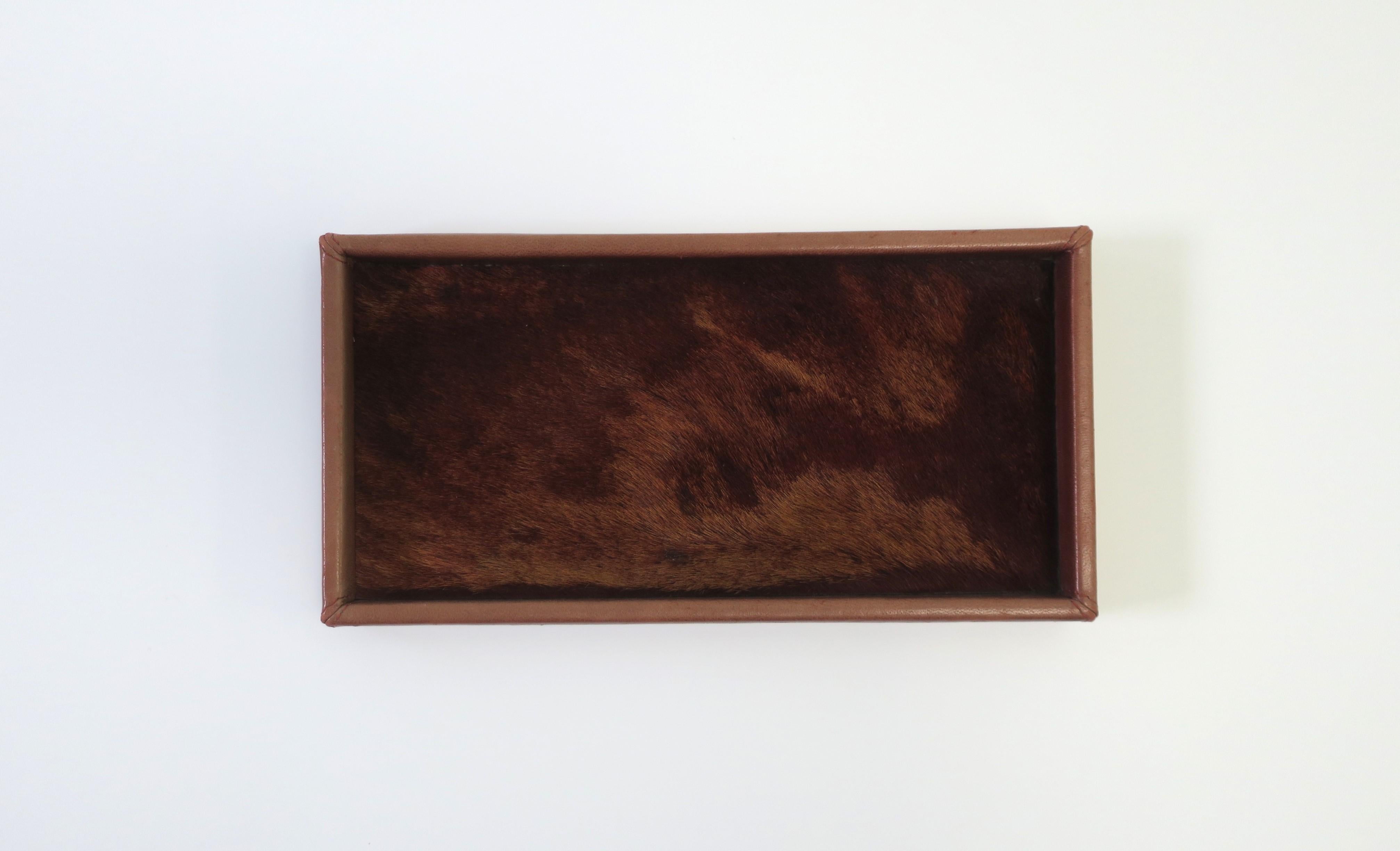 A beautiful French leather and animal hide vanity jewelry tray by designer Gilles Caffier, Paris, France. This monochromatic tray has a leather wrapped frame with a plush animal hide base. A great piece for any vanity, nightstand table, dresser,