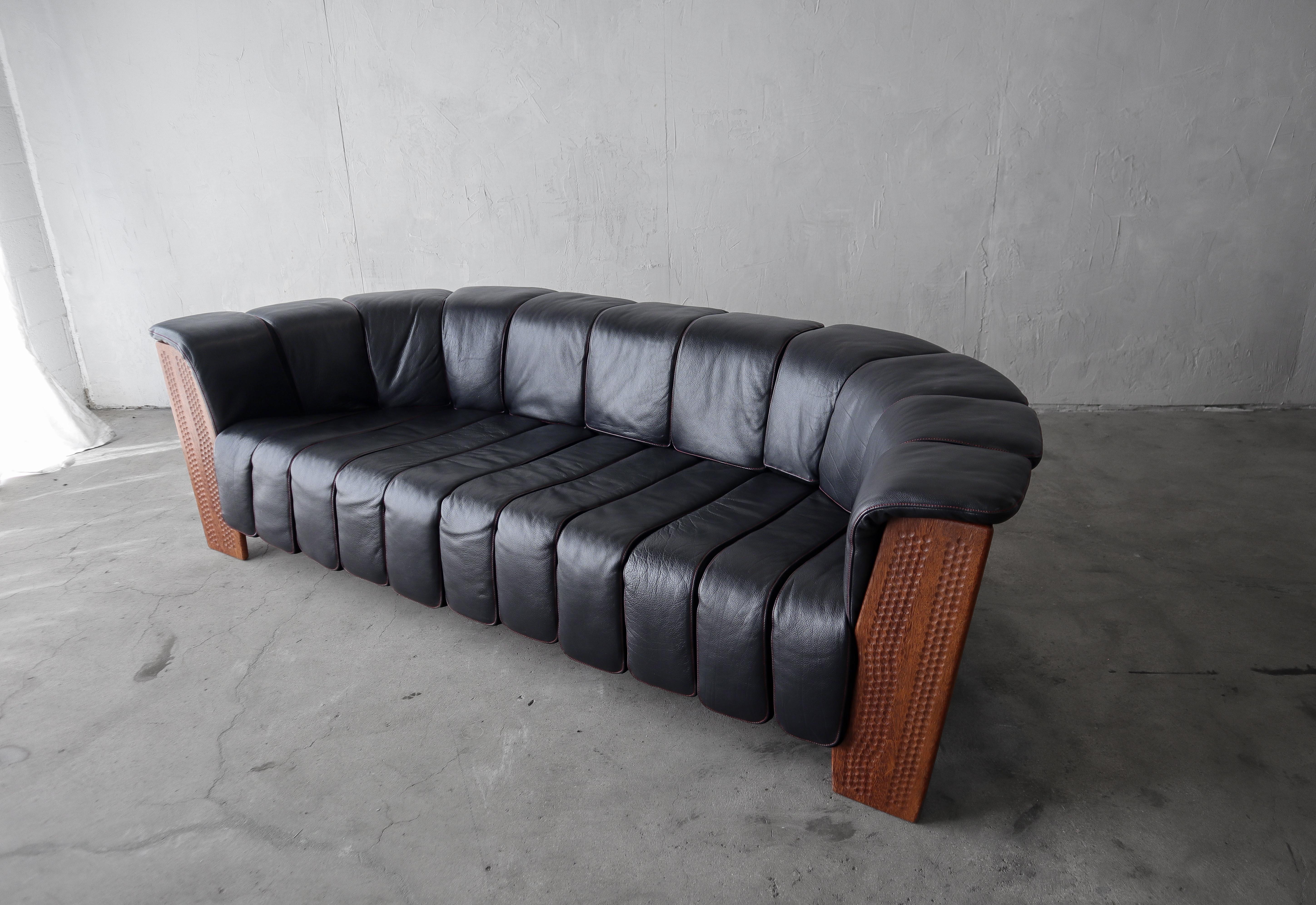 A beautiful leather and palmwood sofa from the Dreamtime Collection by Pacific Green Furniture. Constructed of black leather, suede and Palmwood. This offering is for the oversized chair.
The sofa is in superb condition, with no real imperfections