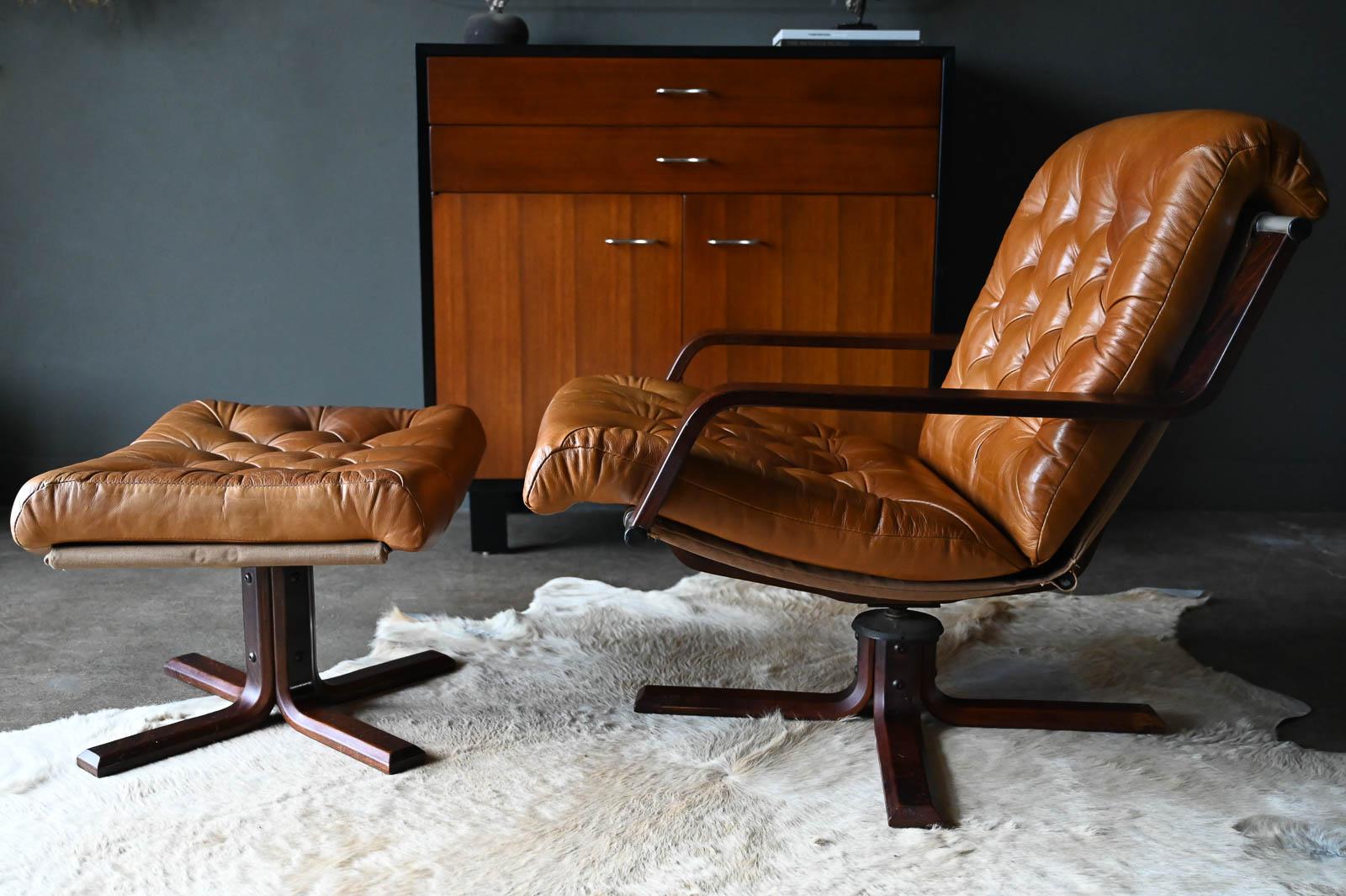 Rare Leather and Rosewood Swivel lounge chair and Ottoman by Sigurd Ressell, 1970. Beautiful untreated saddle leather with great stitching detail in very good original condition with just the perfect amount of patina. Rosewood and chrome frame is