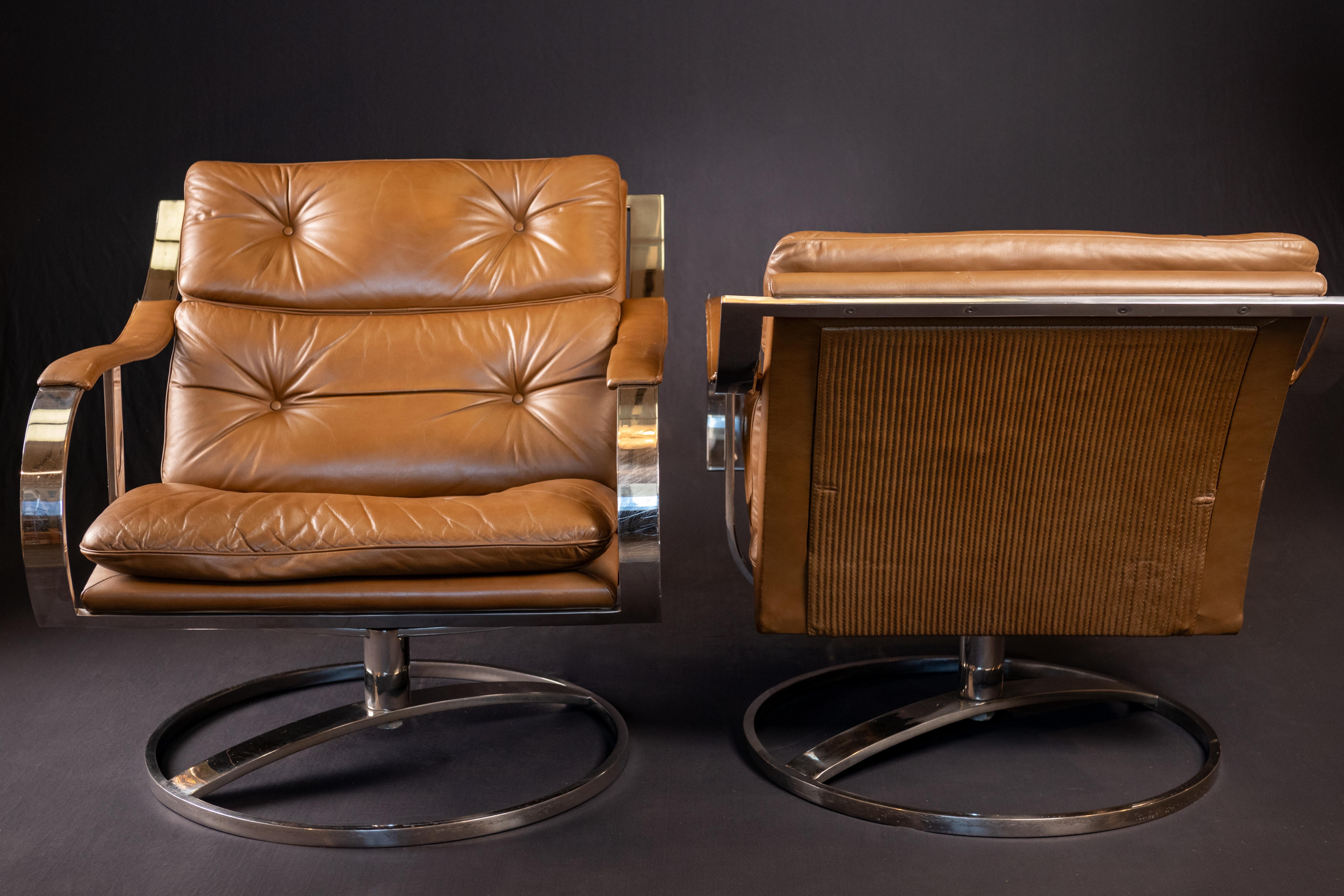 Mid-Century Modern lounge chairs Series 455 designed by Gardner and Leaver for Steelcase, circa 1970 in the USA. The Chairs retain their beautiful deep camel color leather with button tufting, and with flat bar stainless steel frame and a swivel