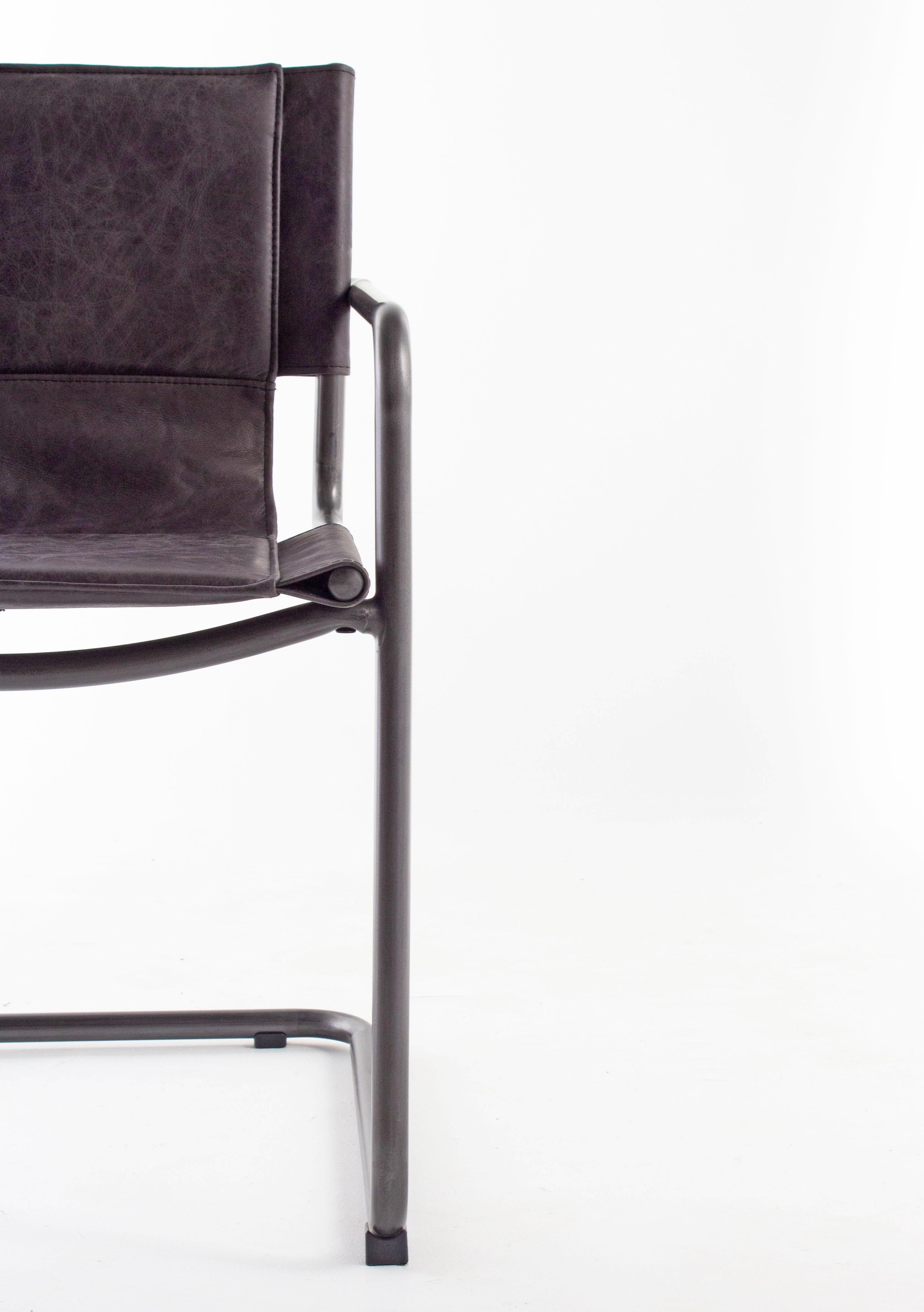 Modern steel and leather sling chair.