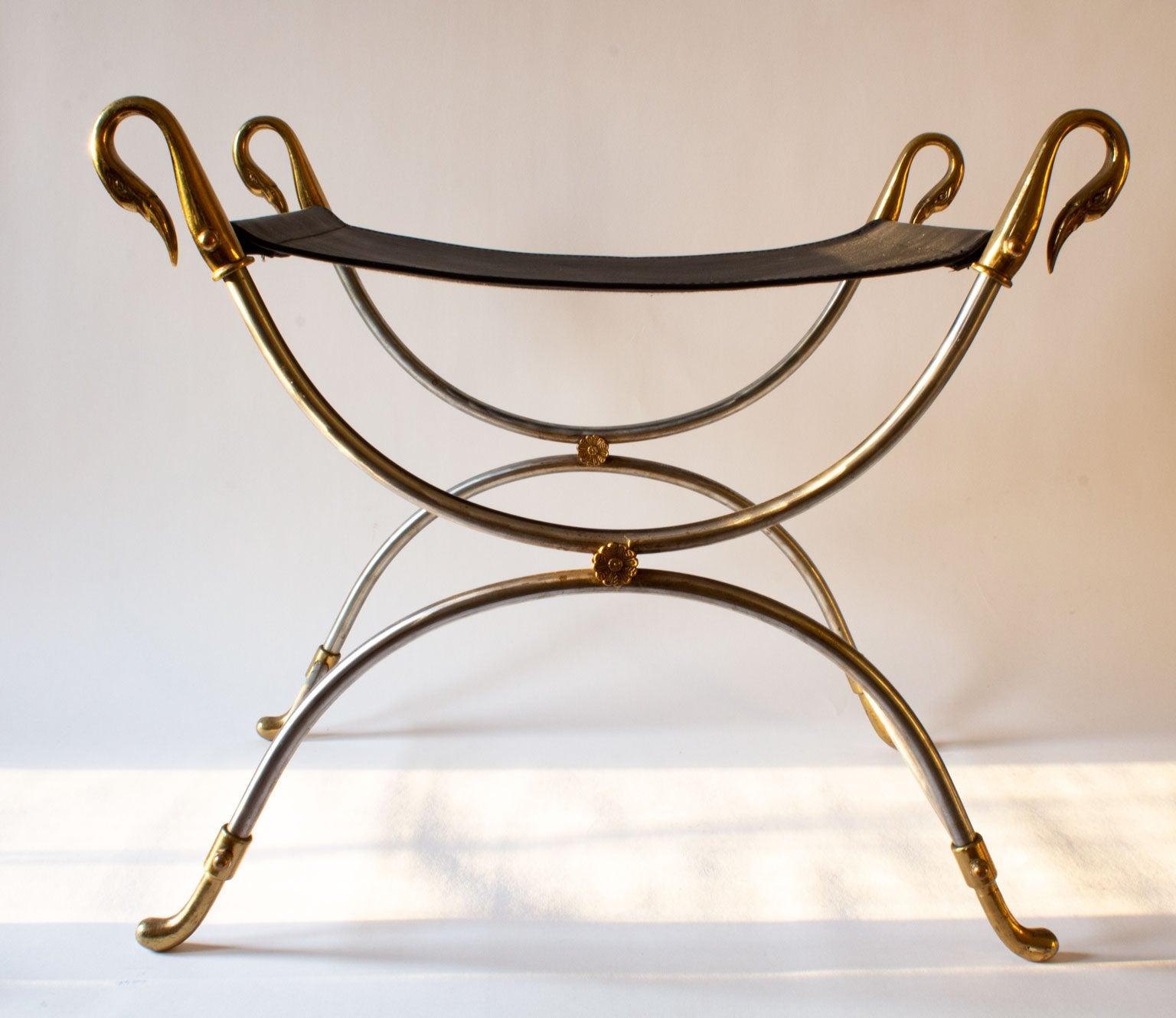 Elegant and stylish leather stool with Swan heads in brass by Maison Jansen, made in France in the 1970s. New leather seat with a frame in brushed steel. The pieces feature a classical Curile leg structure which supports a shaped seat for comfort.
