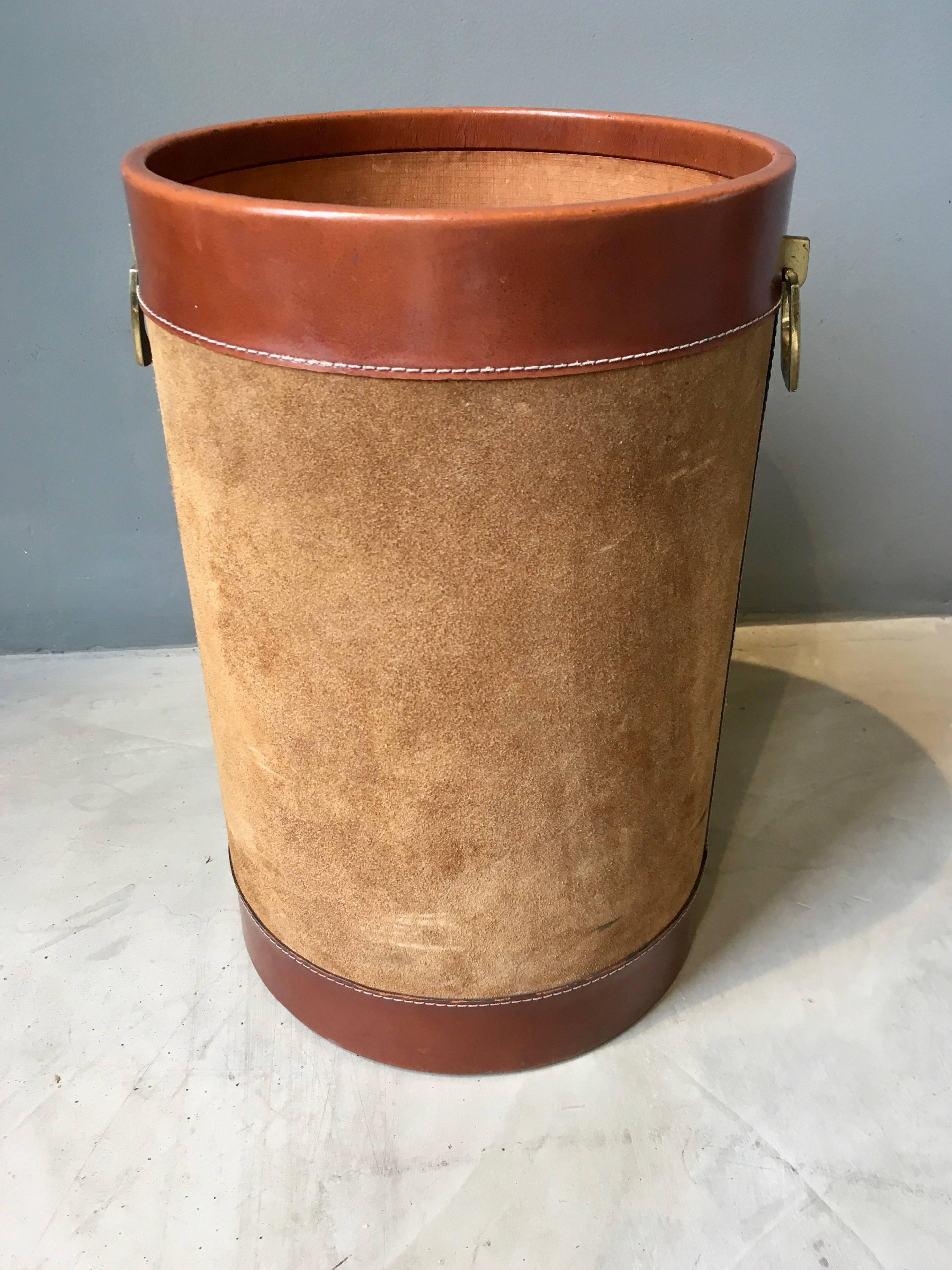 Handsome leather and suede bin in the style of Jacques Adnet. Brass buckles on each side. Gorgeous patina to leather and suede. Fantastic piece!