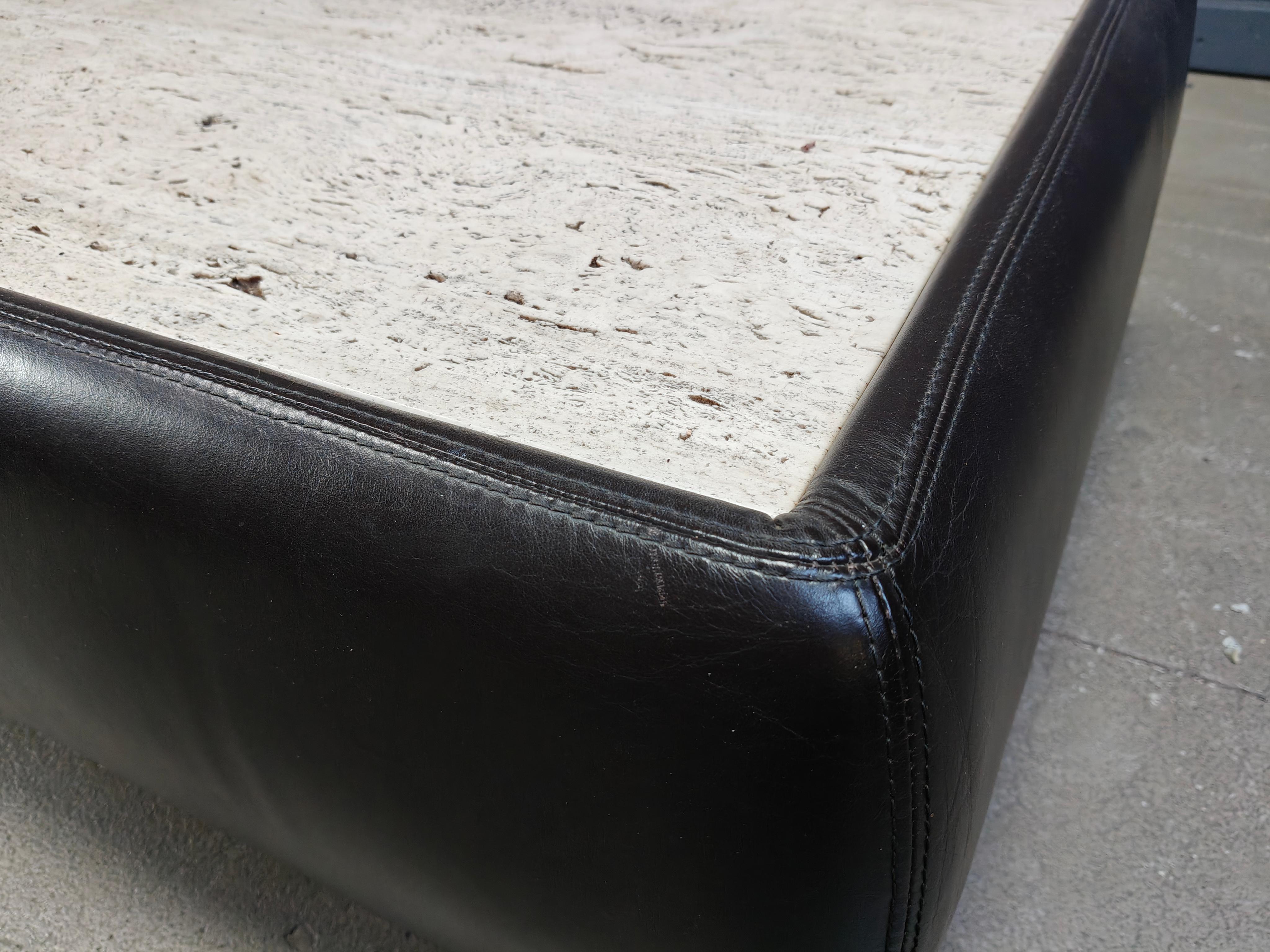 Charming dark brown leather coffee table made from thick leather and natural travertine stone top.

The mix of the fine leather combined with the rough travertine works very well and thus can be combined in lots of interiors.

1970s -