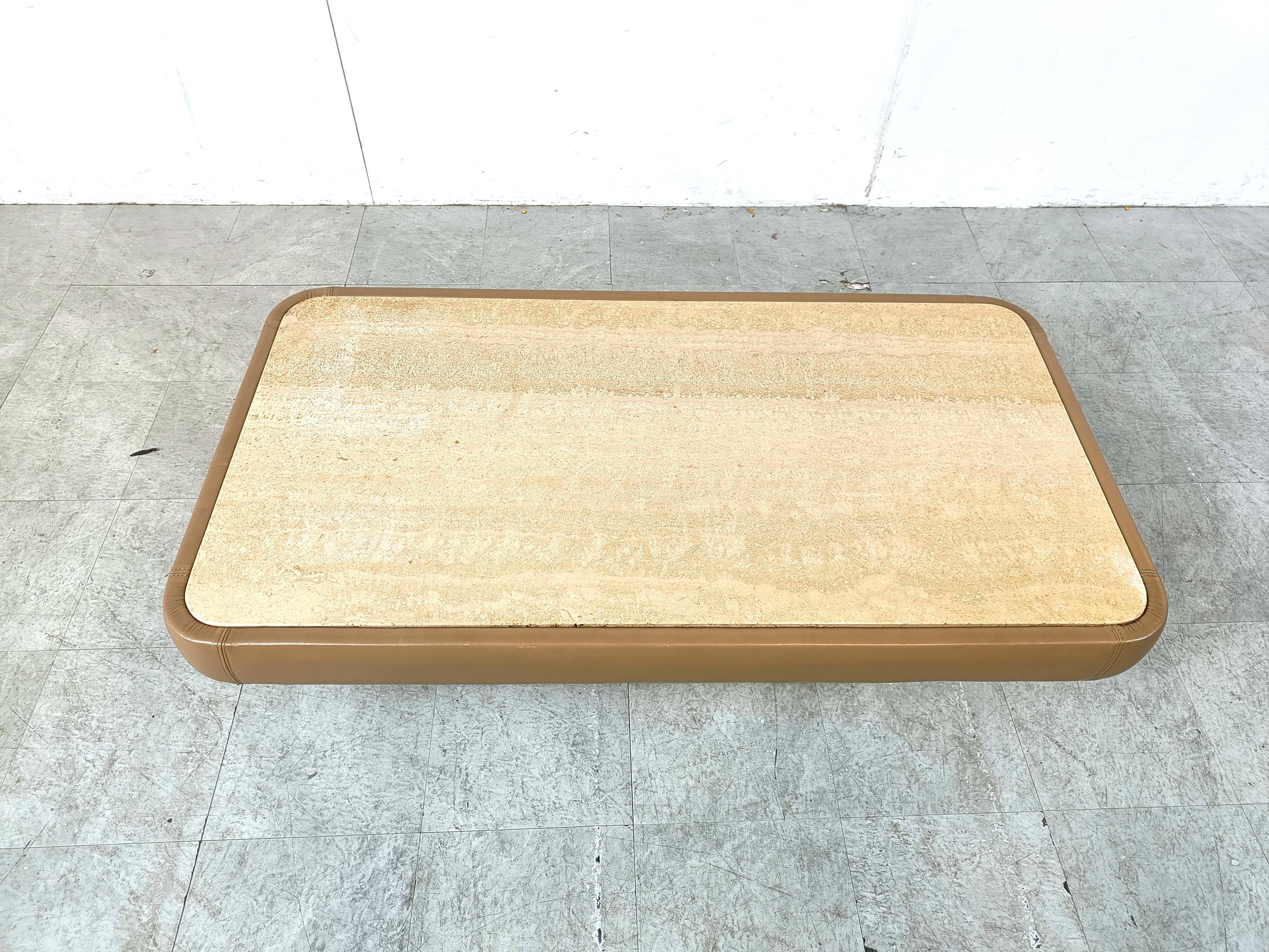Charming leather coffee table by renowned sofa maker deSede of Switzerland.

They make very high quality leather sofas.

They also created this beautiful leather and travertine coffee table. 

Beautiful timeless piece.

1970s - Switzerland

Good