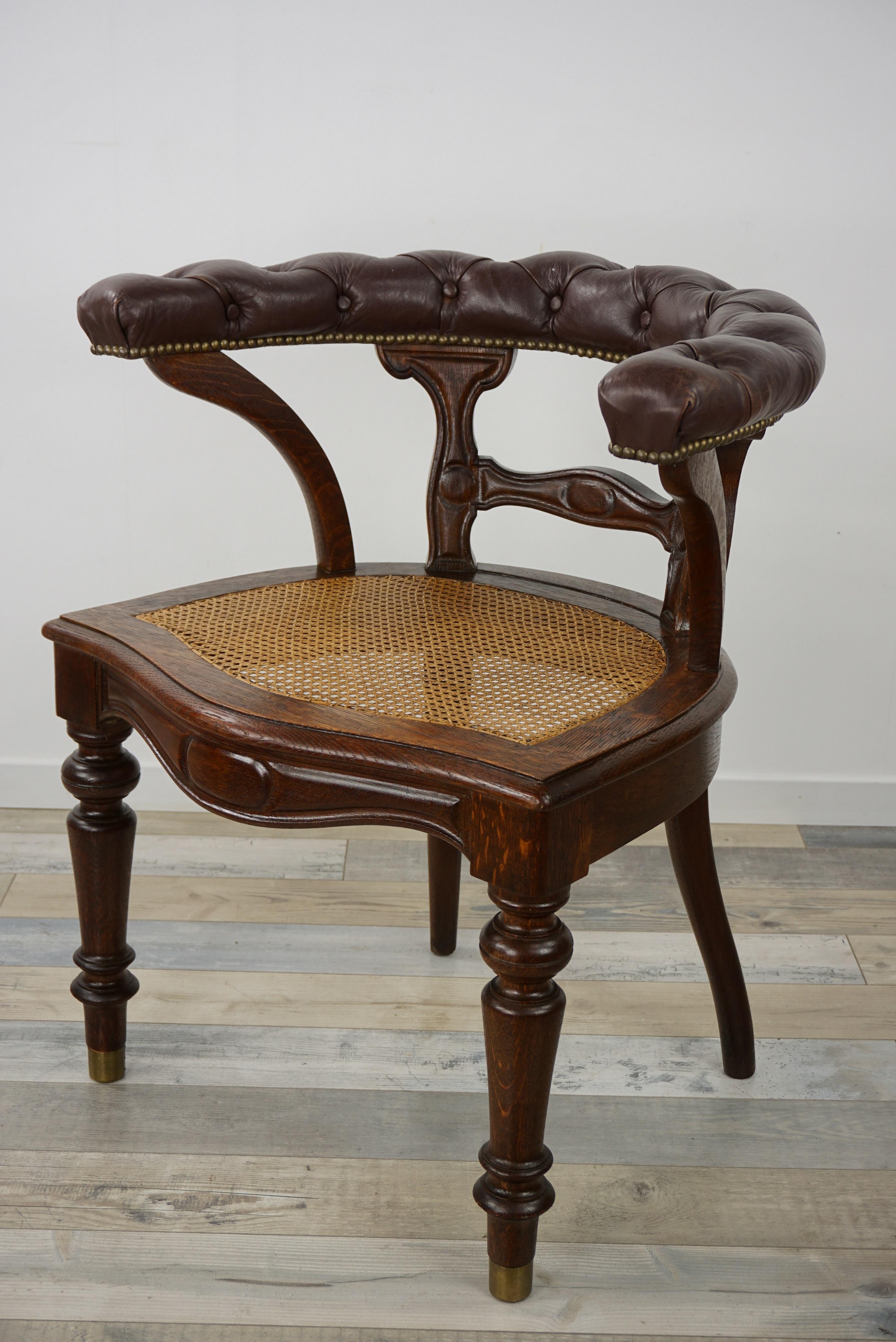 Leather And Wicker Cane 19th century William IV Design antique desk chair composed of an oak wooden structure, finely sculpted, brass finish, a cane wicker seat and padded dark brown leather back.