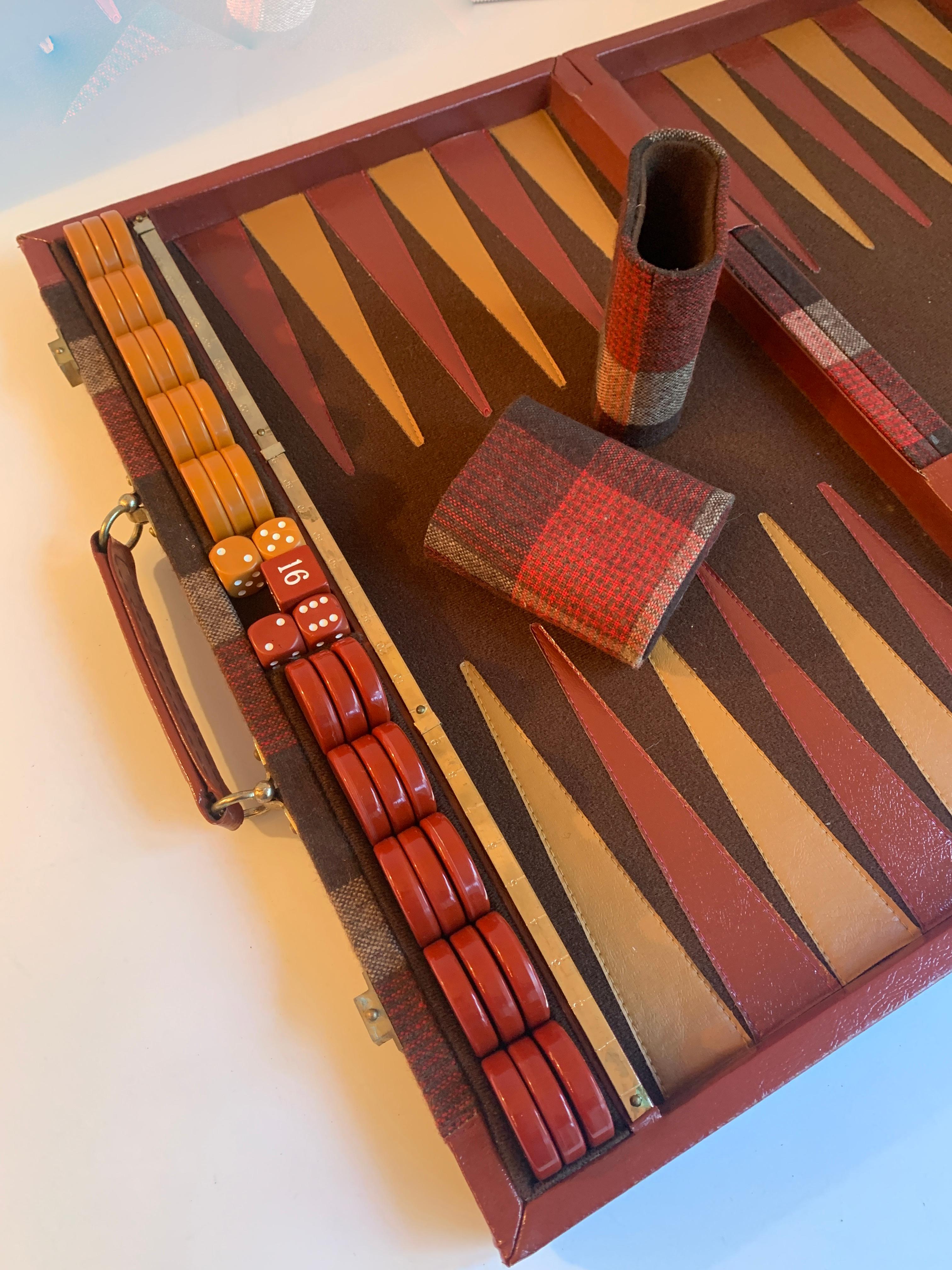 A wonderful travel set of Backgammon - Wool plaid exterior with bakelite game pieces and detailed brass slide for score keeping. A decorative companion to the game room or for the games person on the go!
