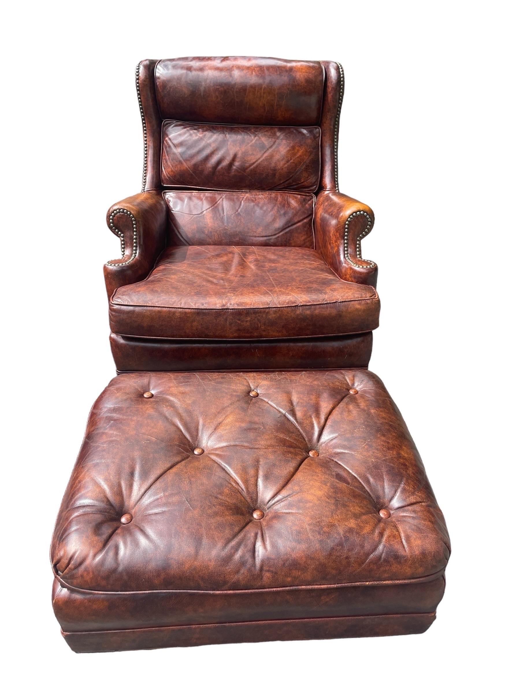 This set is most definitely a Hancock and Moore Armchair and Ottoman set. The label is missing but is the same as many of the same style and brand I have collected in the past. This is a gorgeous set.

Incredibly comfortable top grain leather. The