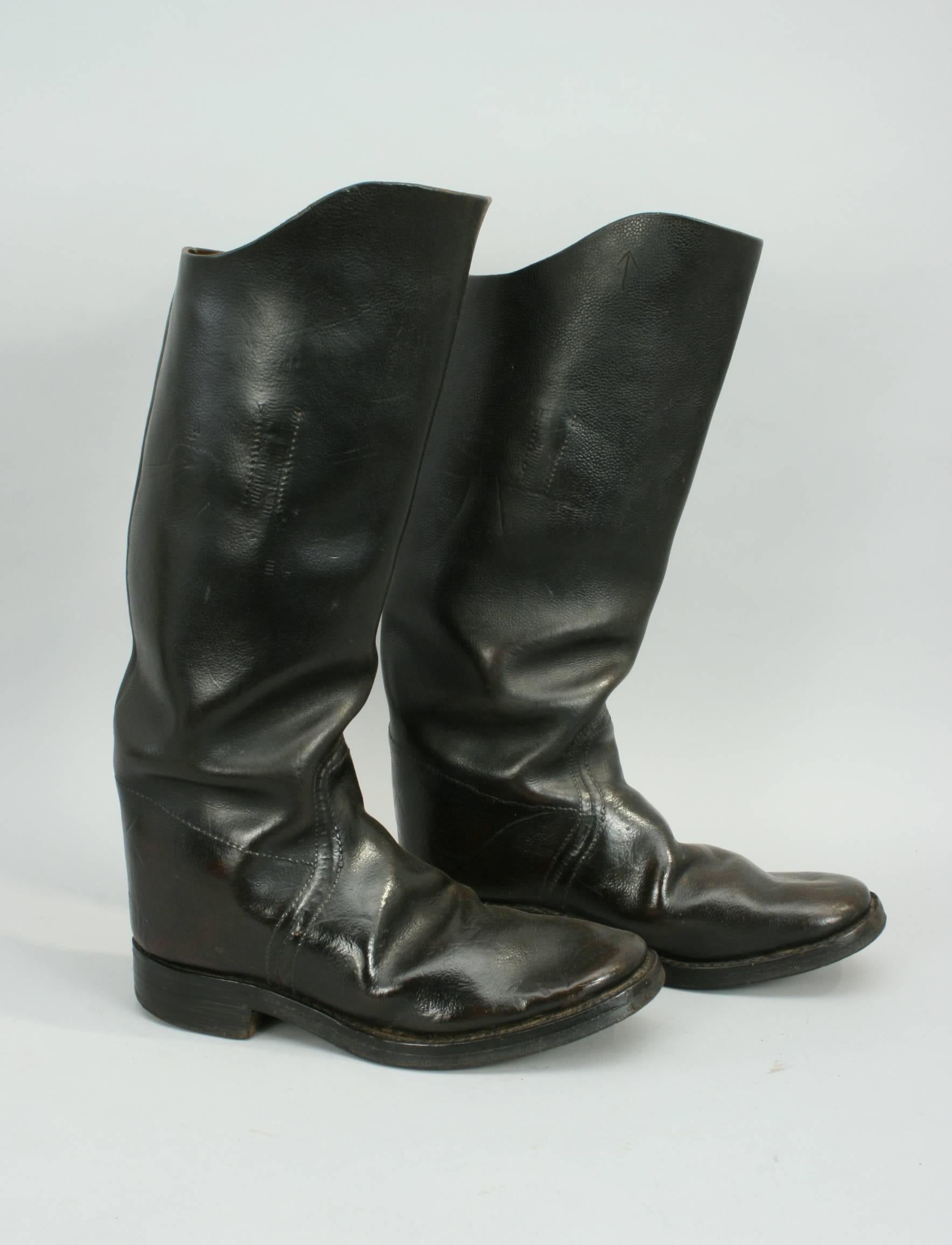 Vintage leather cavalry / artillery boots.
A very good-looking pair of black leather knee high boots. These boots are stamped with an arrow mark suggesting that they were government issue. The boots are stamped with the maker's name 'ADAMS BROS.