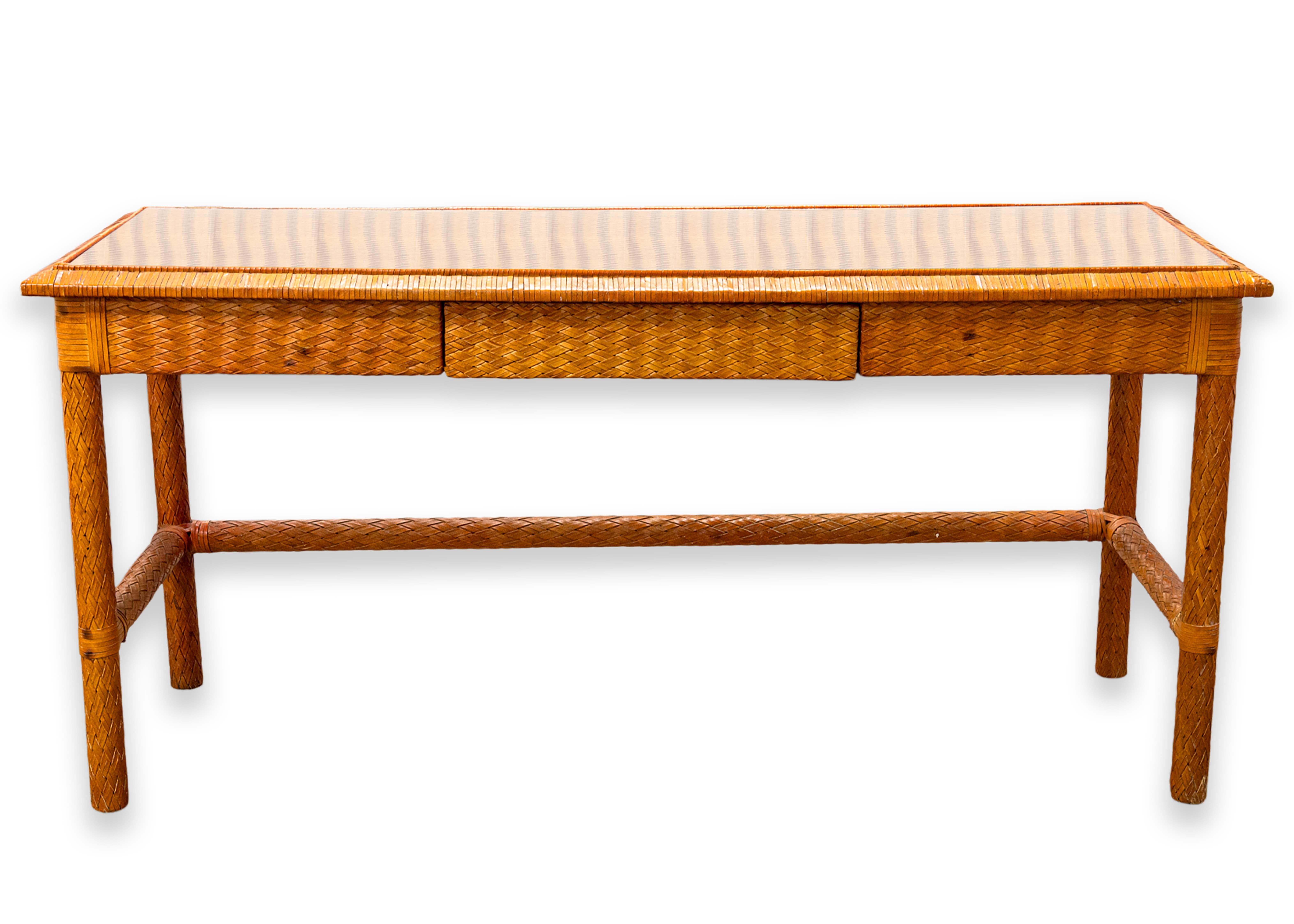 A leather weave console table attributed to McGuire furniture. This gorgeous mid century modern accent table features a very unique design and choice of materials. This piece has a wood frame construction, and an absolutely lovely leather weave