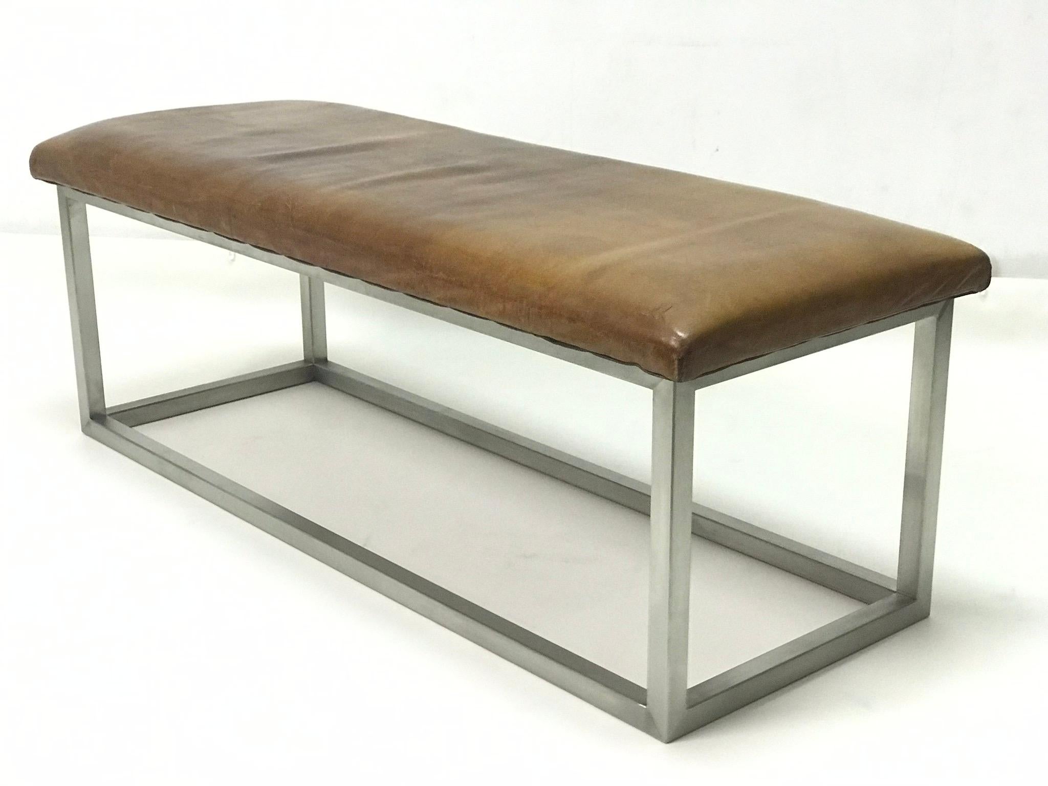 The bench has strong leather completed the stainless steel construction. The leather is in the original patina.