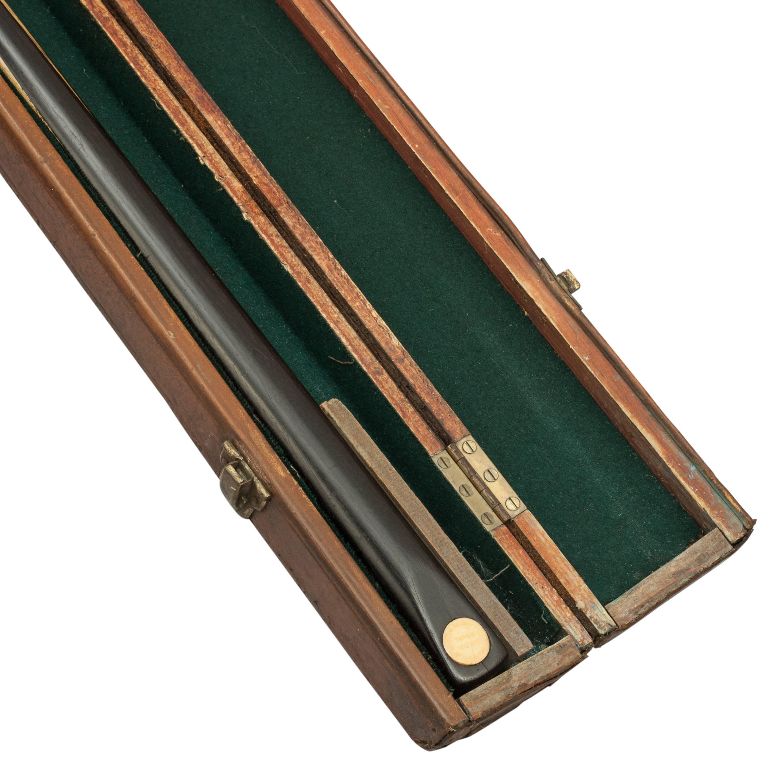 Billiard / Snooker leather cue case with cue.
An Edwardian leather snooker or billiard cue case with compartments for two cues and lined in green baize. The case is fitted with a brass lock, two catches (one broken) and a central leather carry