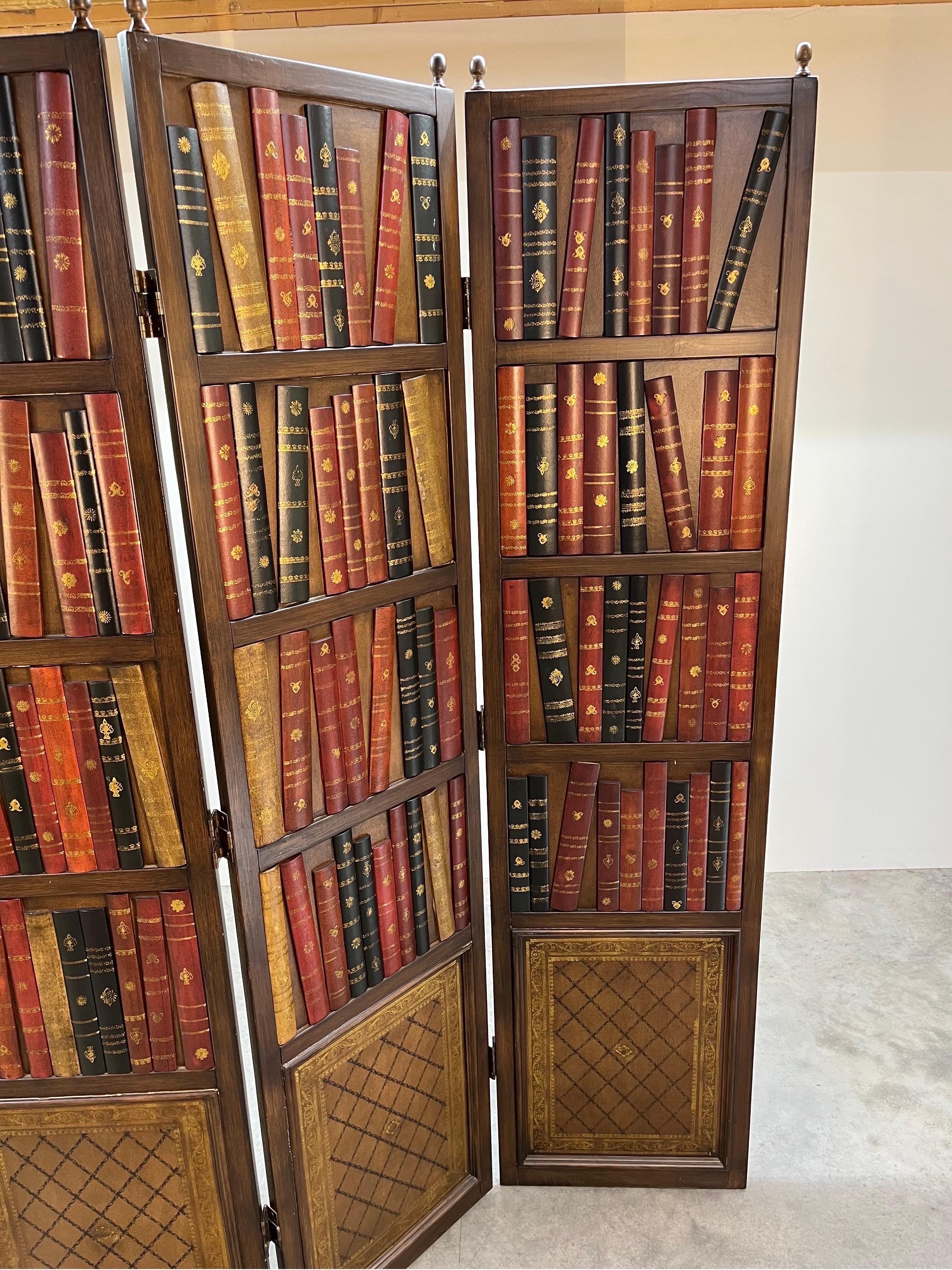 A library style books on shelf room divider having real leather book motif throughout. The perfect addition of subtle color tones and class added to your space for dividing or as a privacy screen. 
In fantastic vintage condition. 