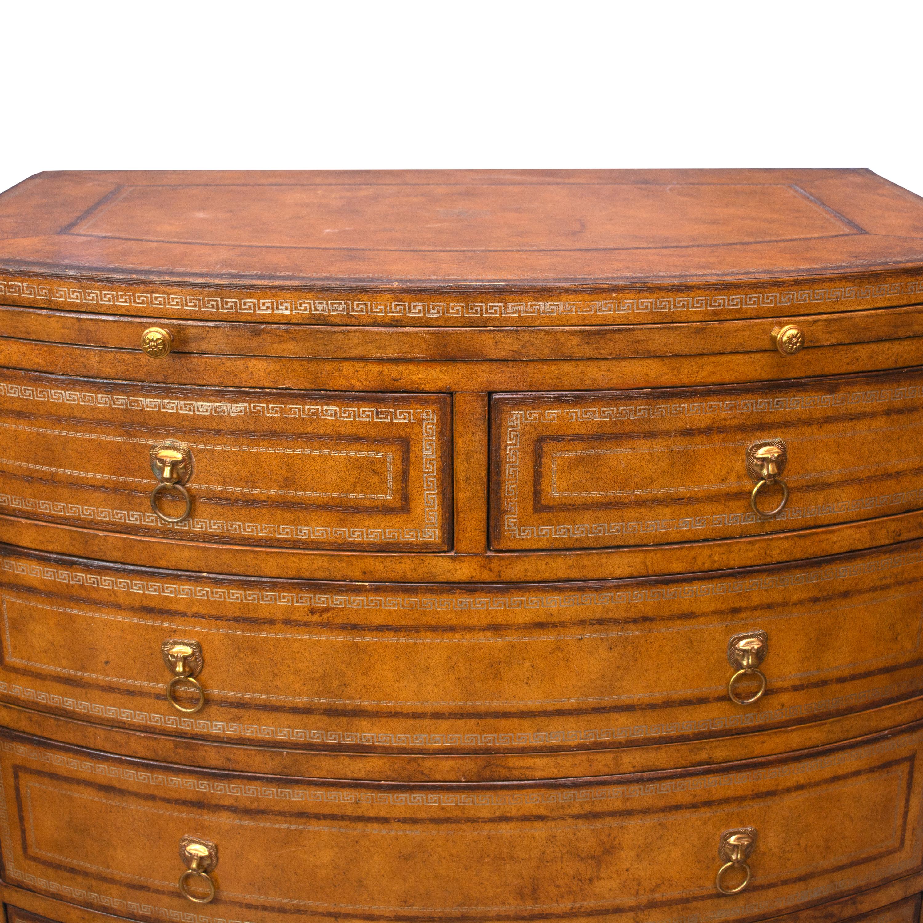 This is a unique bowfront chest of drawers, unique in that it is veneered with leather. The top section and frieze contains a brush slide over two short and three long graduated drawers, raised on splay feet flanking a shaped apron.
