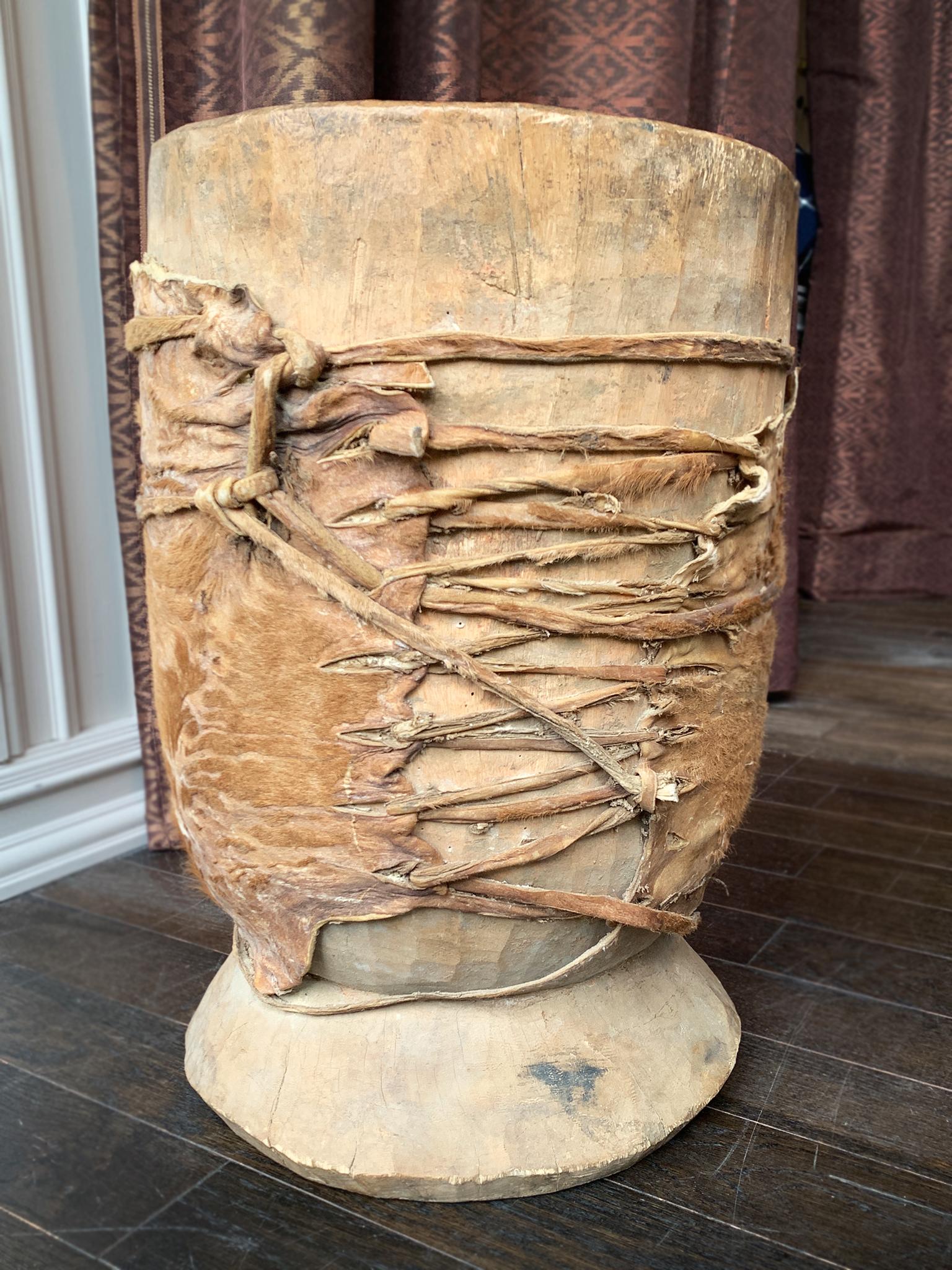 Made in the 19th Century, this vessel was hand-carved from hornbeam wood and has  substantial weight. It is wrapped in a leather hide. We love the beautifully tactile and naturally weathered surfaces that give the vessel a sense of time and history.