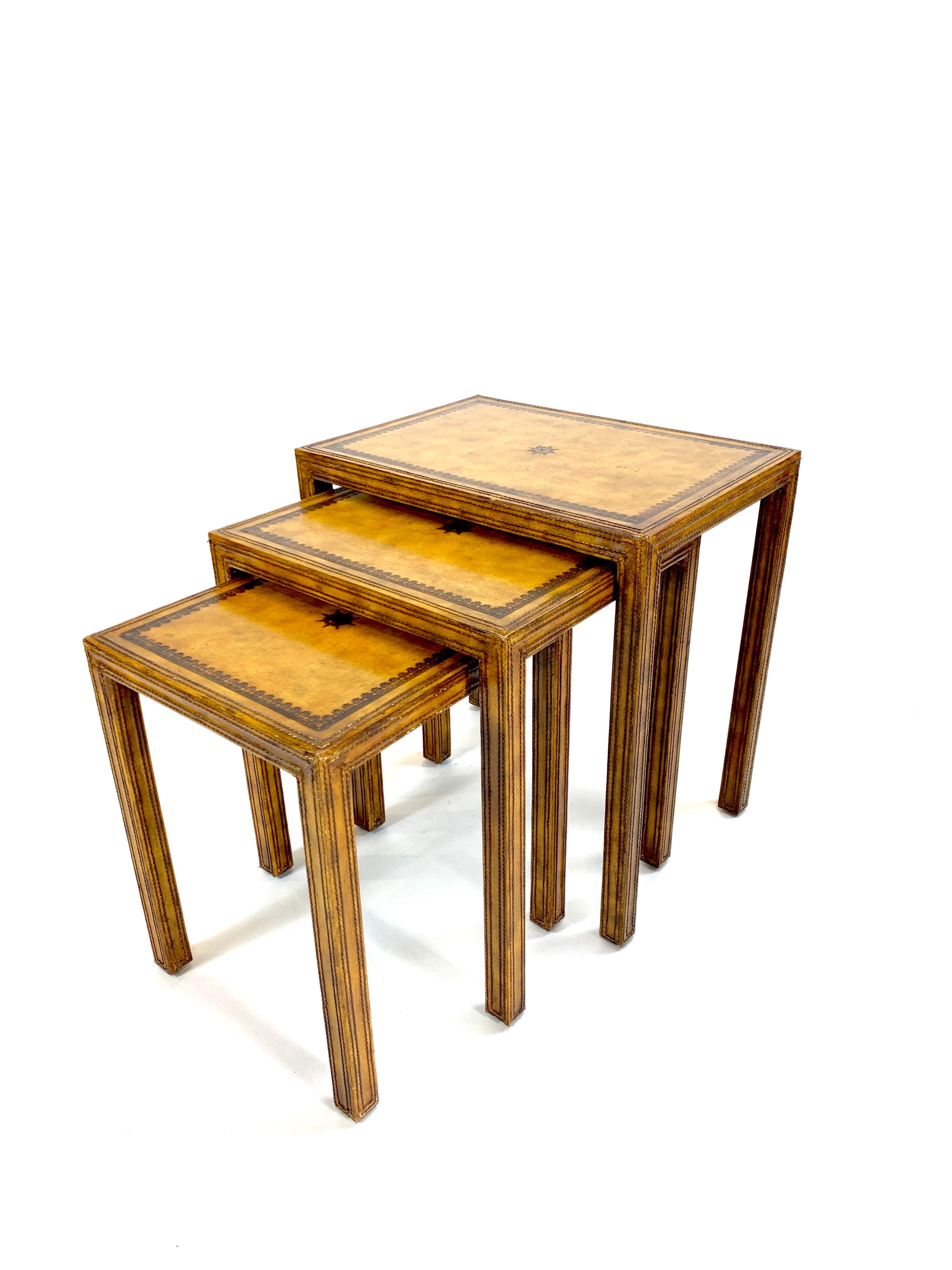 Substantial yet diminutive set of 3 nesting tables by Maitland Smith. Meticulous leatherwork and pyrography evident in these beautiful tables.