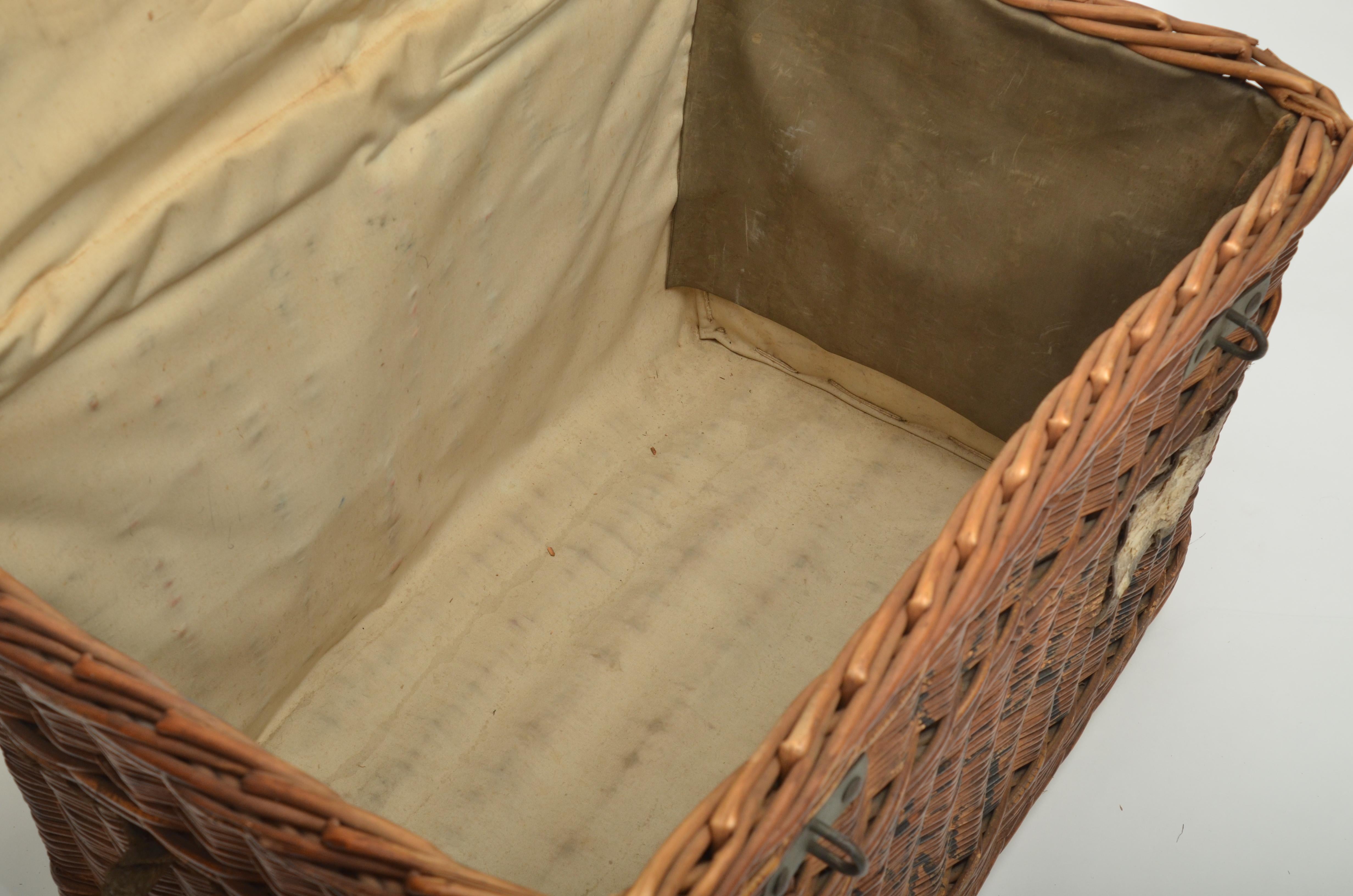 Originally used as a laundry basket with rope handles and wrought iron clasps.
  