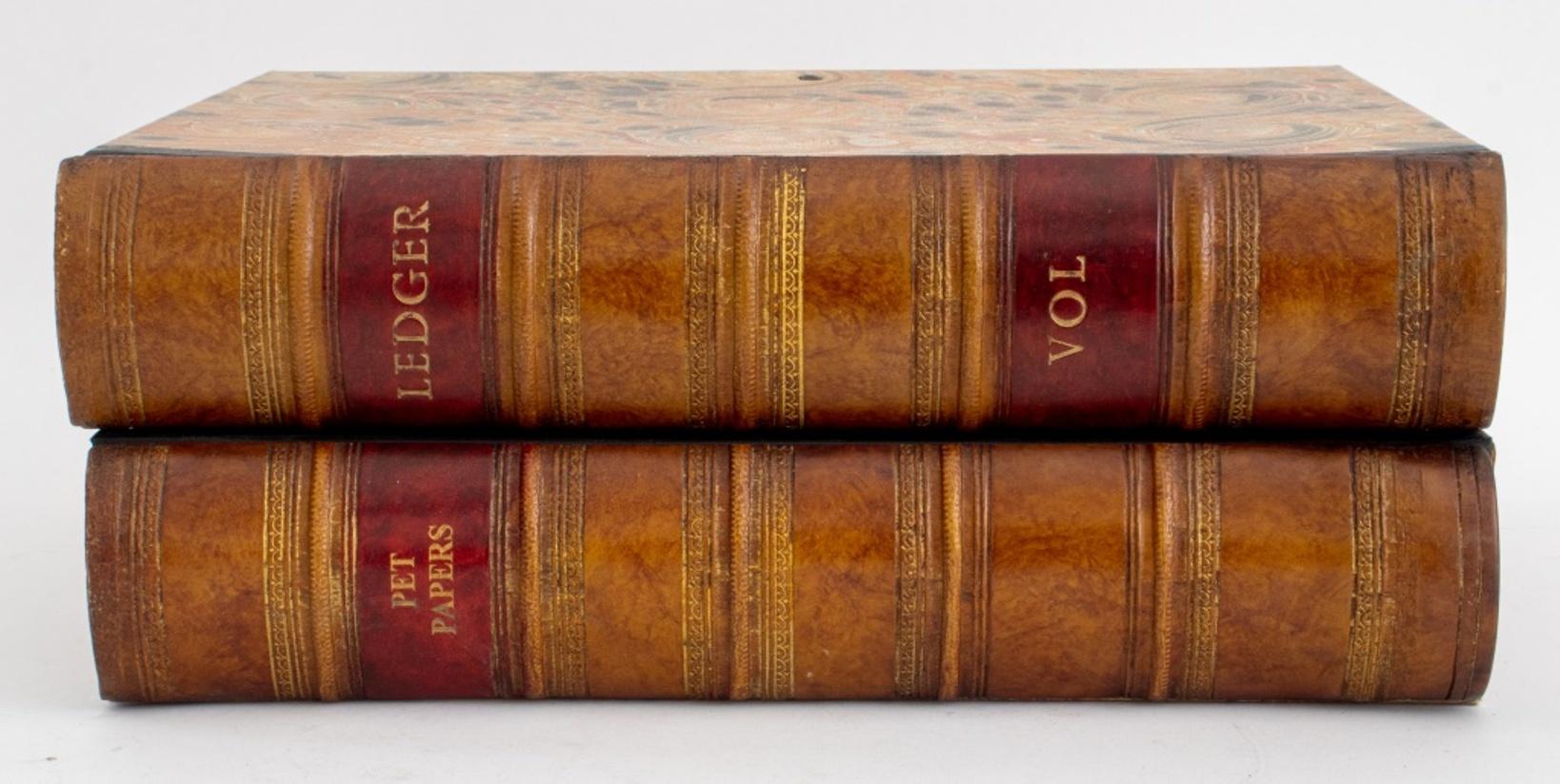 Group of two folder with gilt decorated brown leather bounded faux-book edges.

Dimensions: Each: approx. 14.5