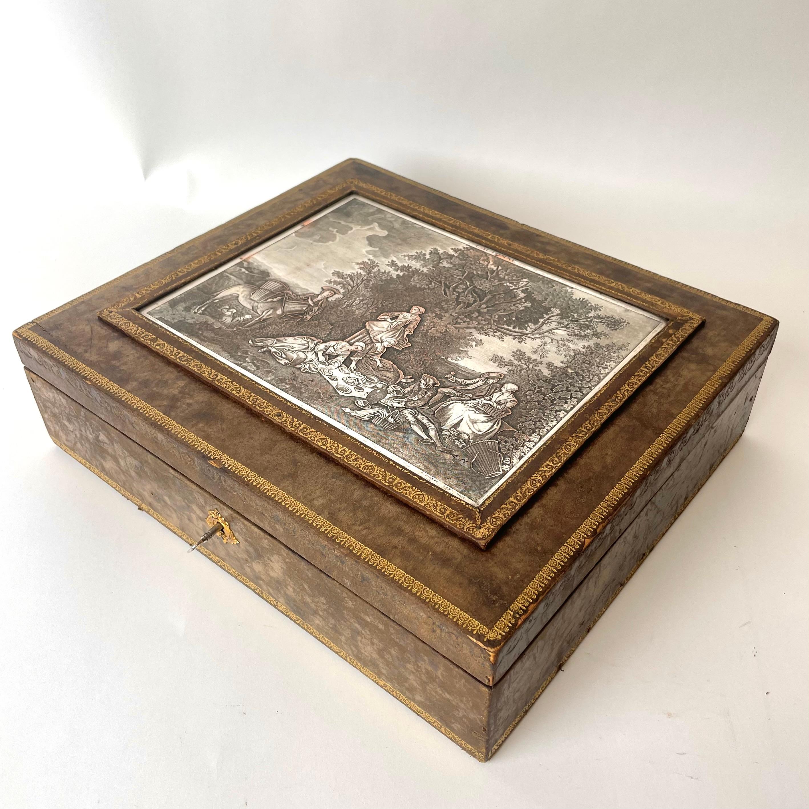 Leather Box with Decorative Silver plated Engraving based upon Lancret. Made in France in the late 19th century. 
Beautiful leather box with embossed gold details at edges. A silver plated engraved copperplate by Paris-based 19th century engraving