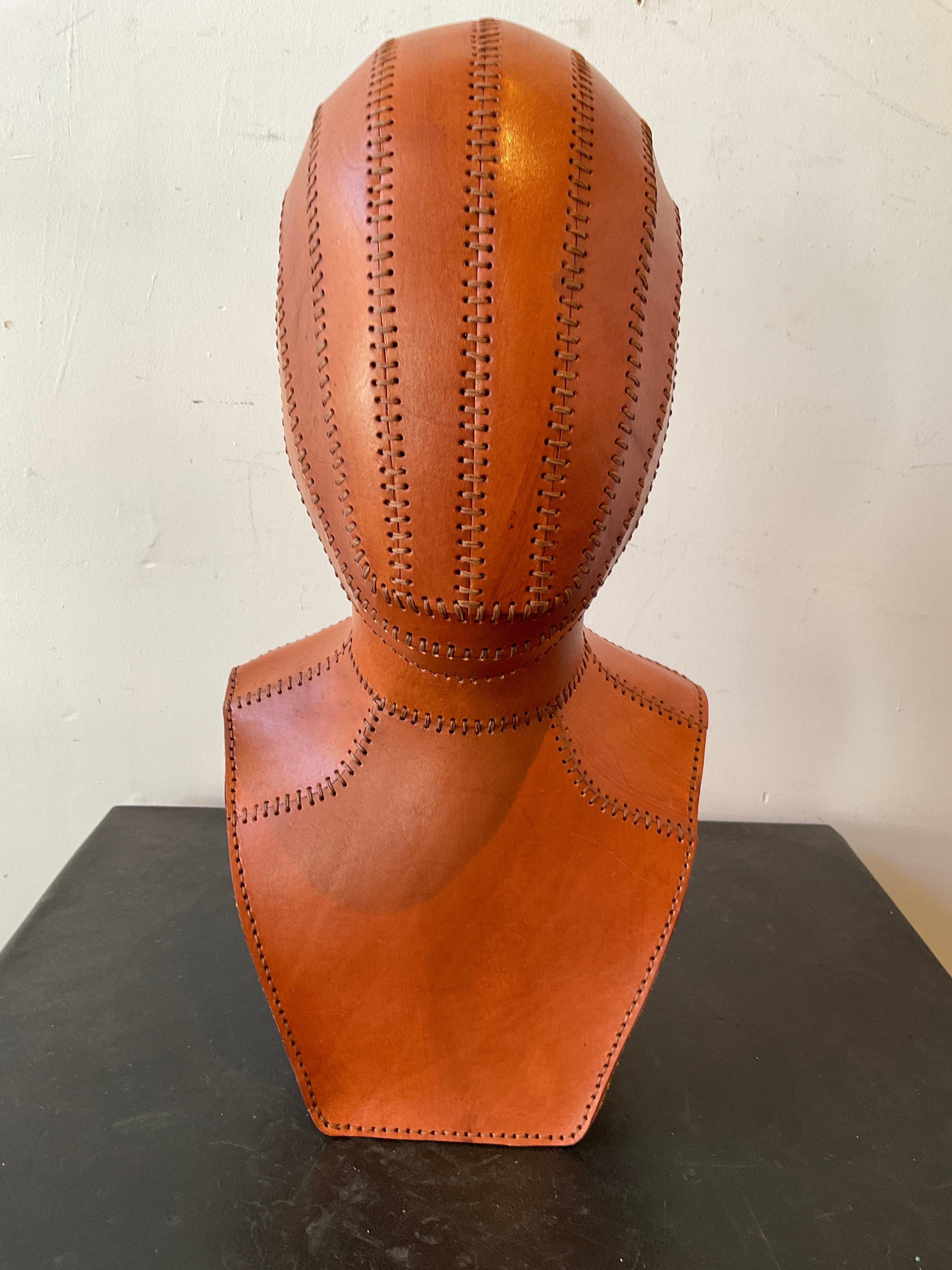 Hand made leather bust made by a local artisan. Takes 4 days to make.  Some of the pictures look like the bust is stained, those are shadows.