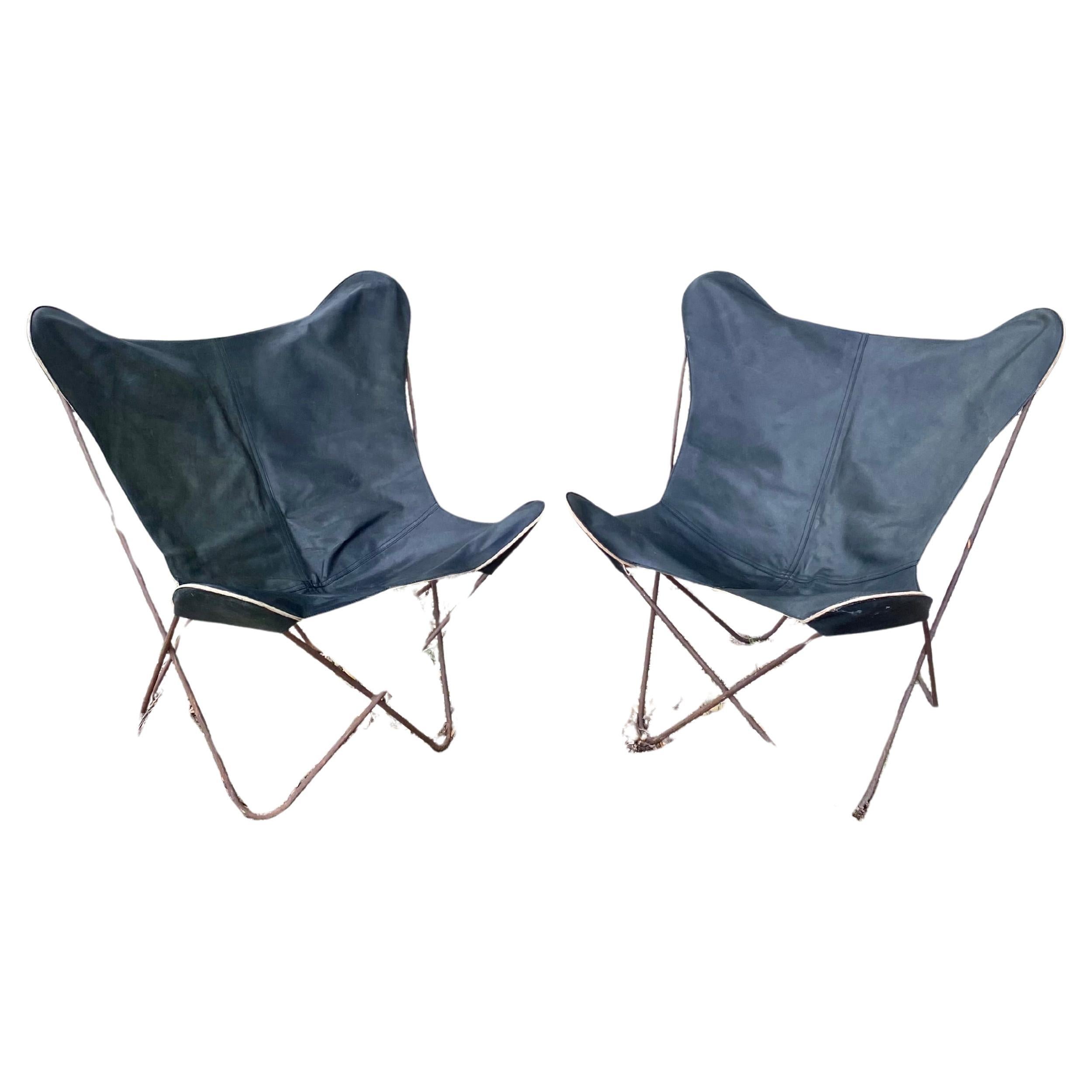 Vintage, Midcentury modern, pair of butterfly chairs (vintage production attributed to Jorge Ferrari-Hardoy for Knoll International) with black leather slings (about 20 years old) and welded iron frames. We love the wear on the frames, which gives