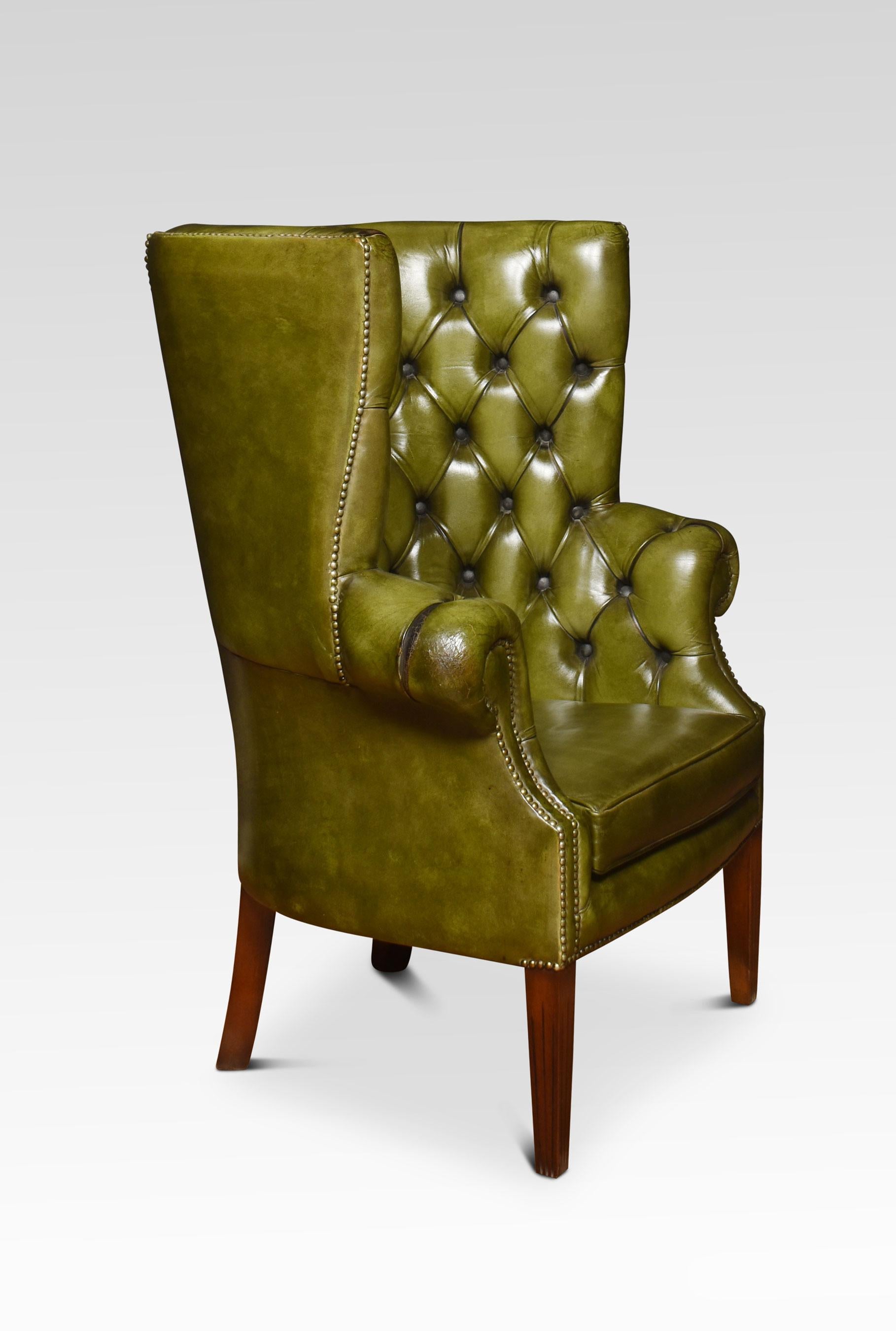 Green leather button-back Chesterfield style wingback armchair, having studded button back over the scrolled armrests. Raised on tapering carved legs.
Dimensions
Height 44.5 inches height to seat 18 inches
Width 35 inches
Depth 29 inches.