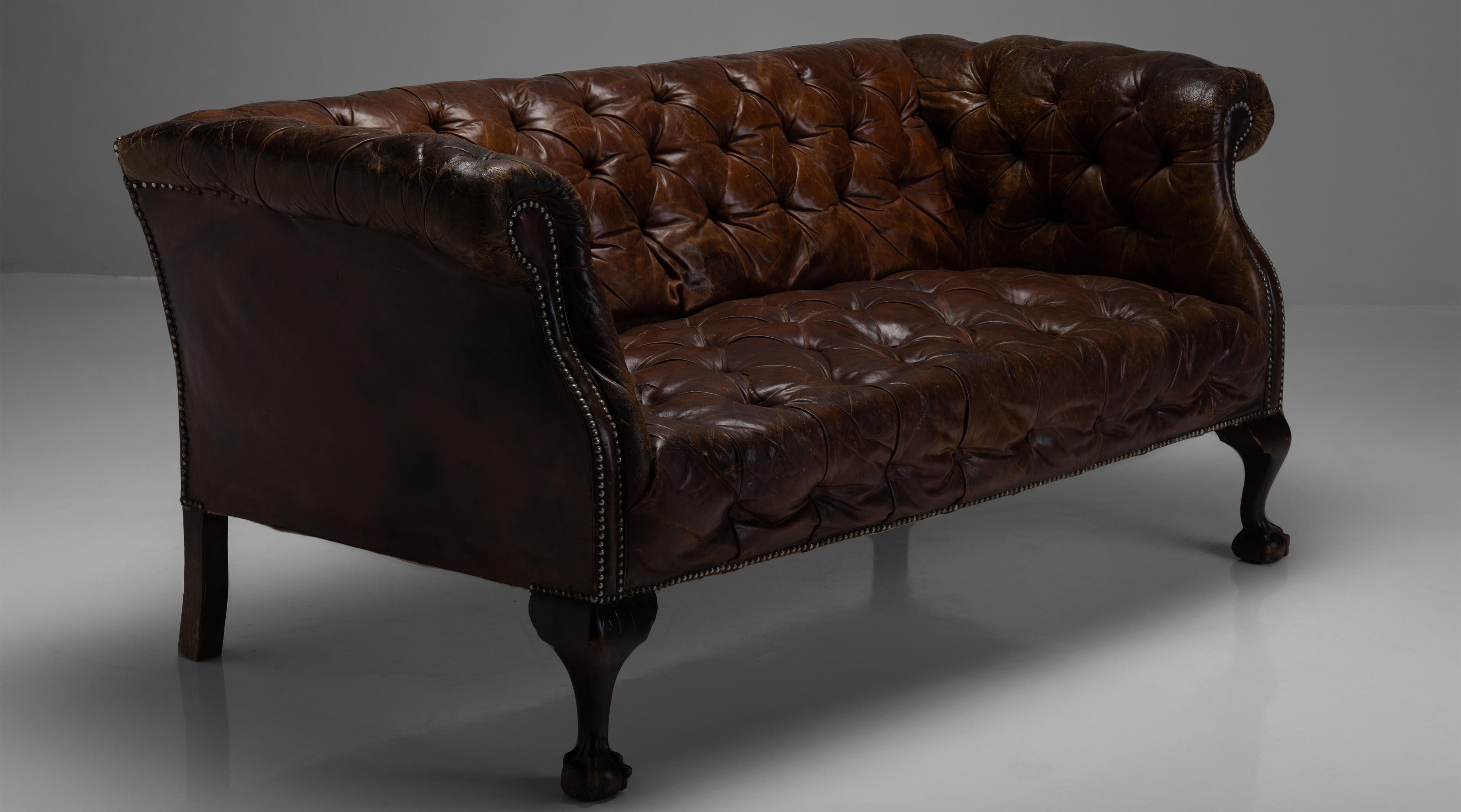Leather Chesterfield Two Seater Sofa

England, Circa 1900

Buttoned sofa with original leather upholstery on ball and claw legs.