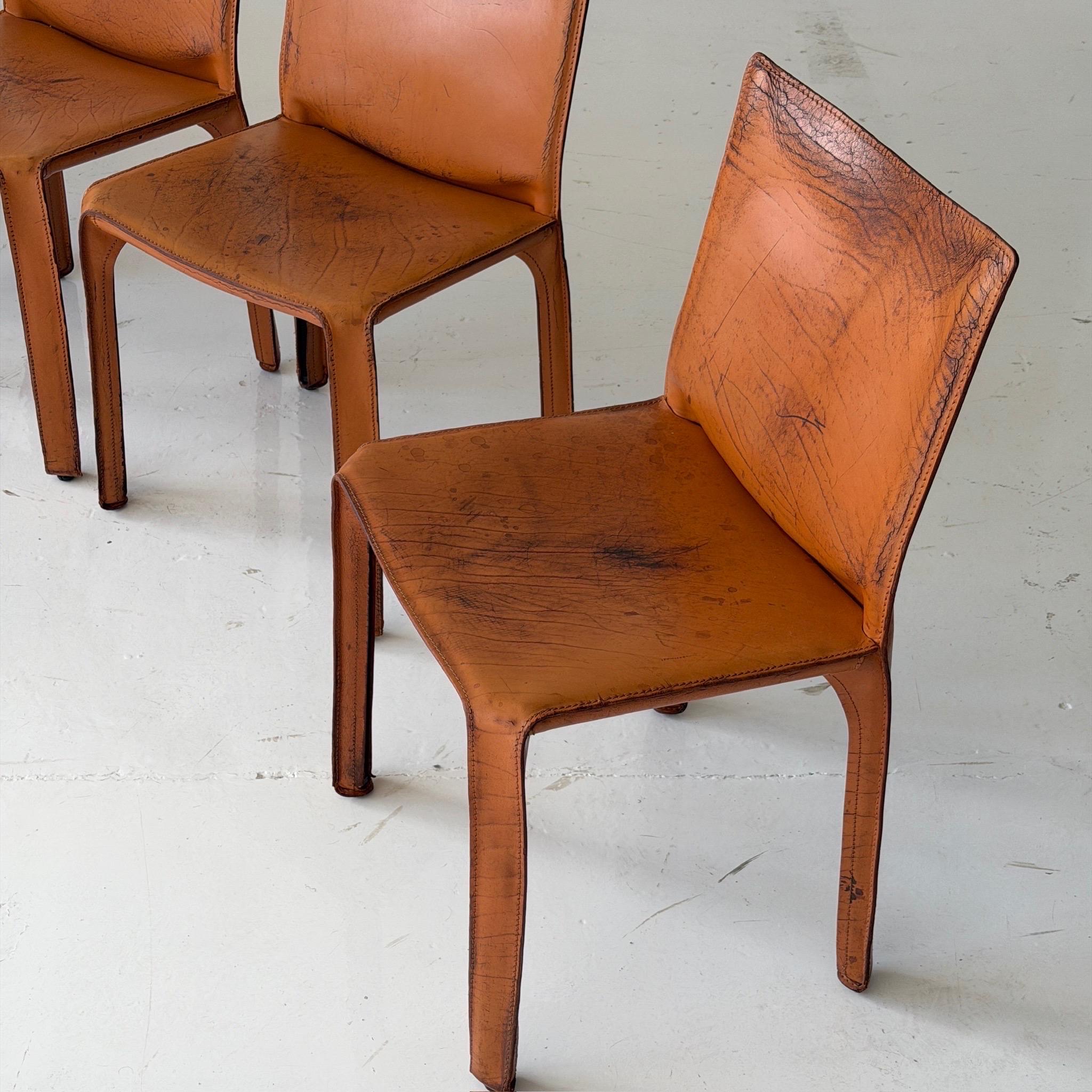 c. 1980s. Price is for the set. Contact us if you’d like to purchase a single item. Brown leather cab chairs with arms. Tagged. 

