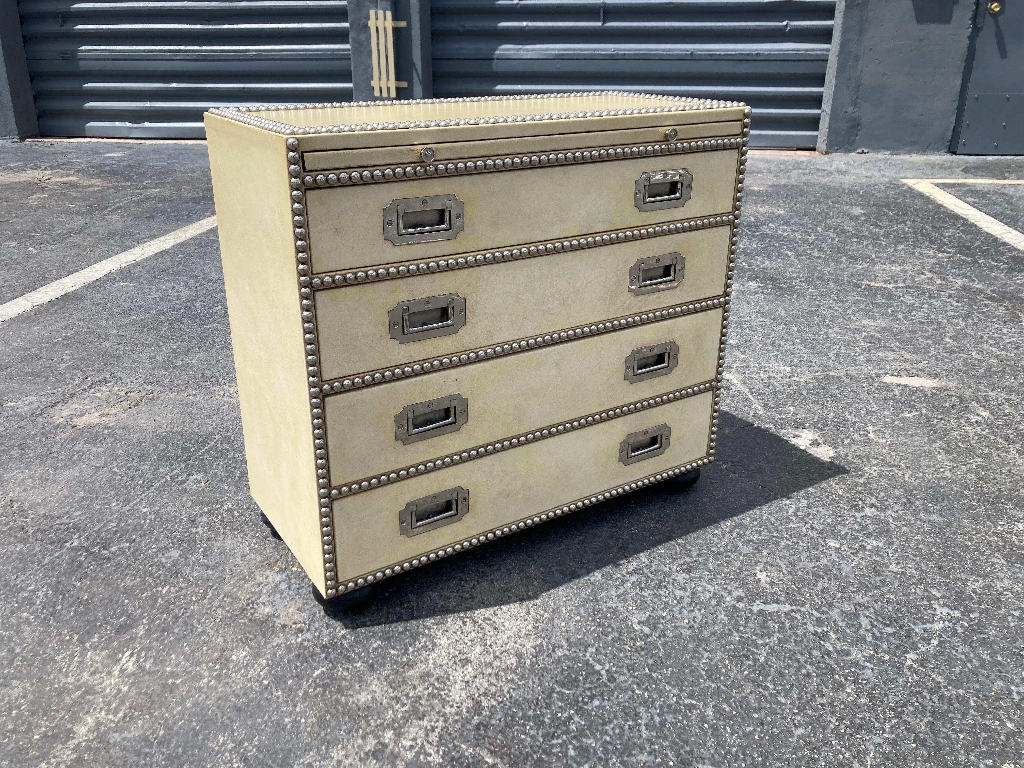 Leather Campaign Chest of drawers. Nickel hardware and tacks, leather with patina. The chest has four drawers and one pull out writing board.