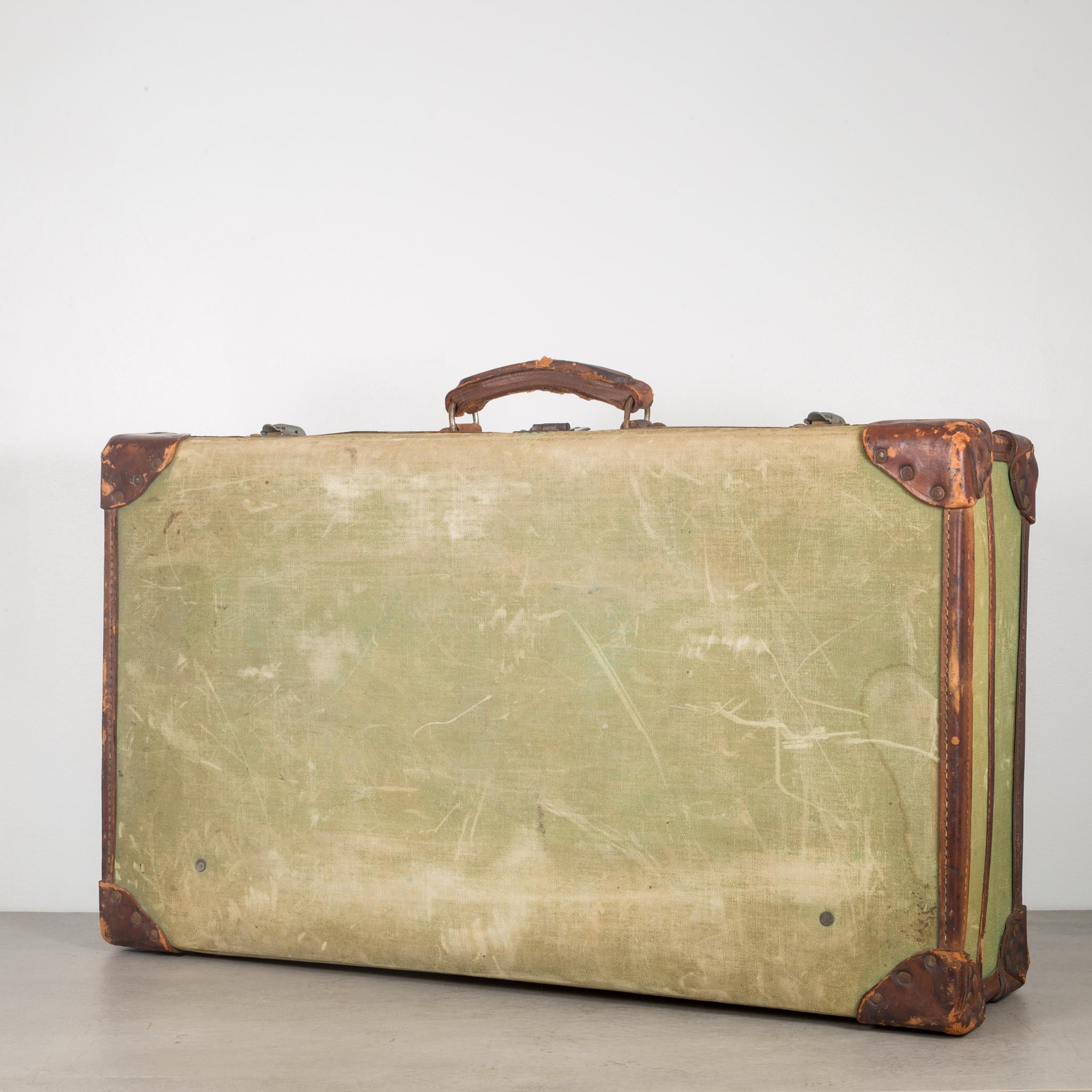 About

This is an original English canvas and leather suitcase stamped 