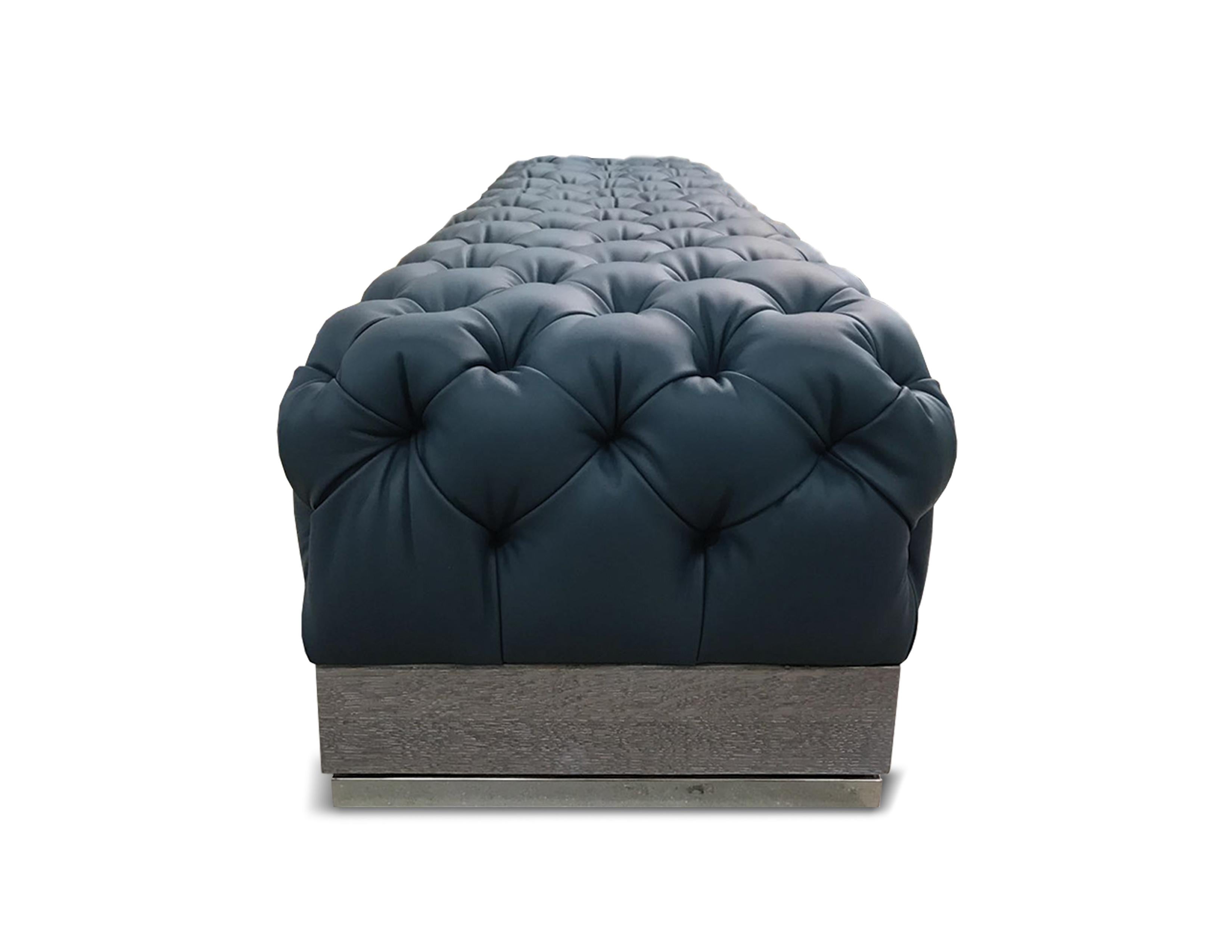 NUBE Ottoman: The ottoman is inspired by a cloud and gives a contemporary twist to the classic Capitonné. Our artisans’ mastery of this special technique shows in the skillfully tufted seating grounding on a European oak frame with noble metal feet.