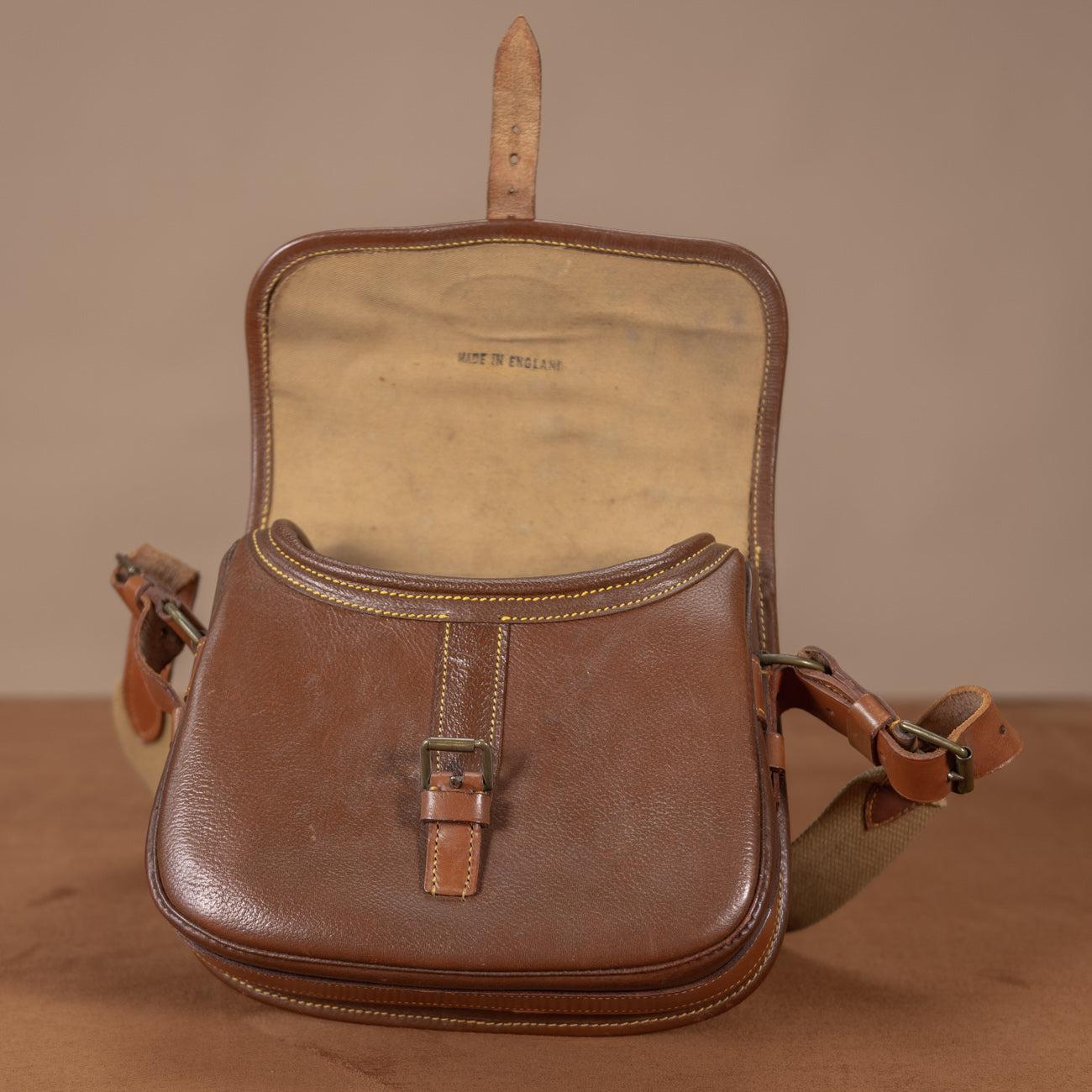 A superb condition textured leather cartridge bag designed to carry 100 shells, circa 1960. Good quality; sturdy leather, stitching, canvas and brass fittings. With hardly any wear inside or out. Unusually this bag has not been embossed with