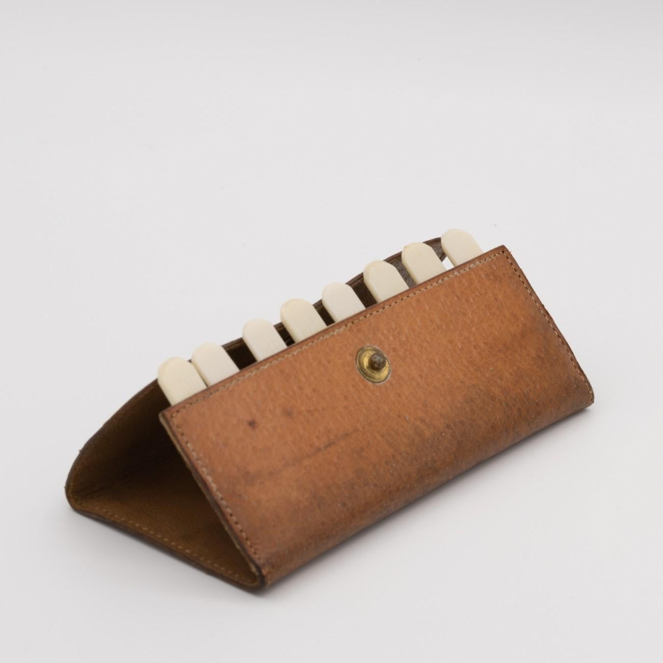 An unusual pigskin leather cased butt marker or peg finder for shooting circa 1930 with eight numbered celluloid pegs.

Dimensions: 9.75 cm/3⅞ inches (length) x 4.75 cm/1⅞ inches (height)

Bentleys are Members of LAPADA, the London and Provincial