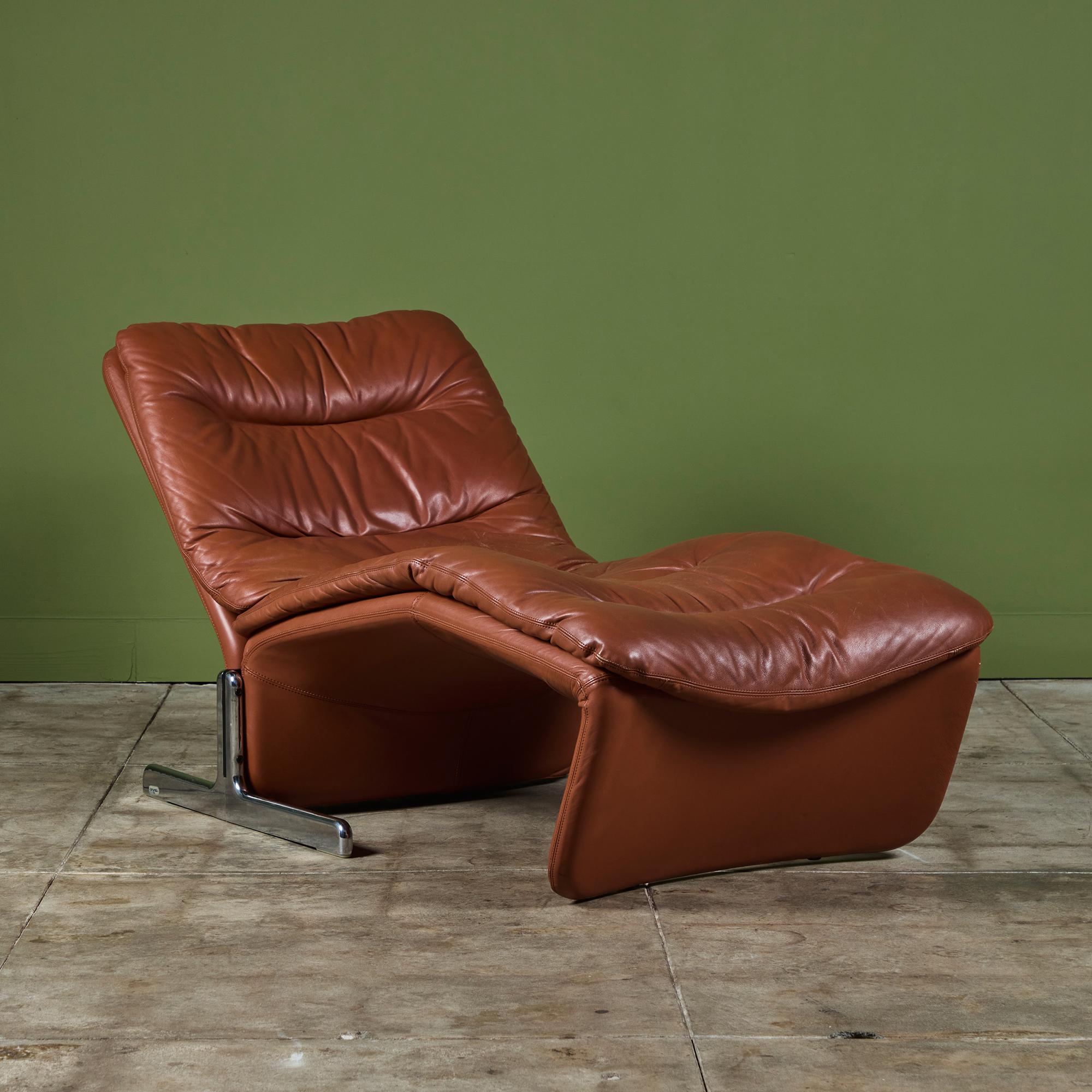 Chaise Lounge by Titina Ammannati and Giampiero Vitelli for Brunati, c.1970's, Italy. The brown leather chaise lounge chair features a leather wrapped frame and an aluminum T base. The seat of the chaise has a tufted leather cushion.

Dimensions
31”