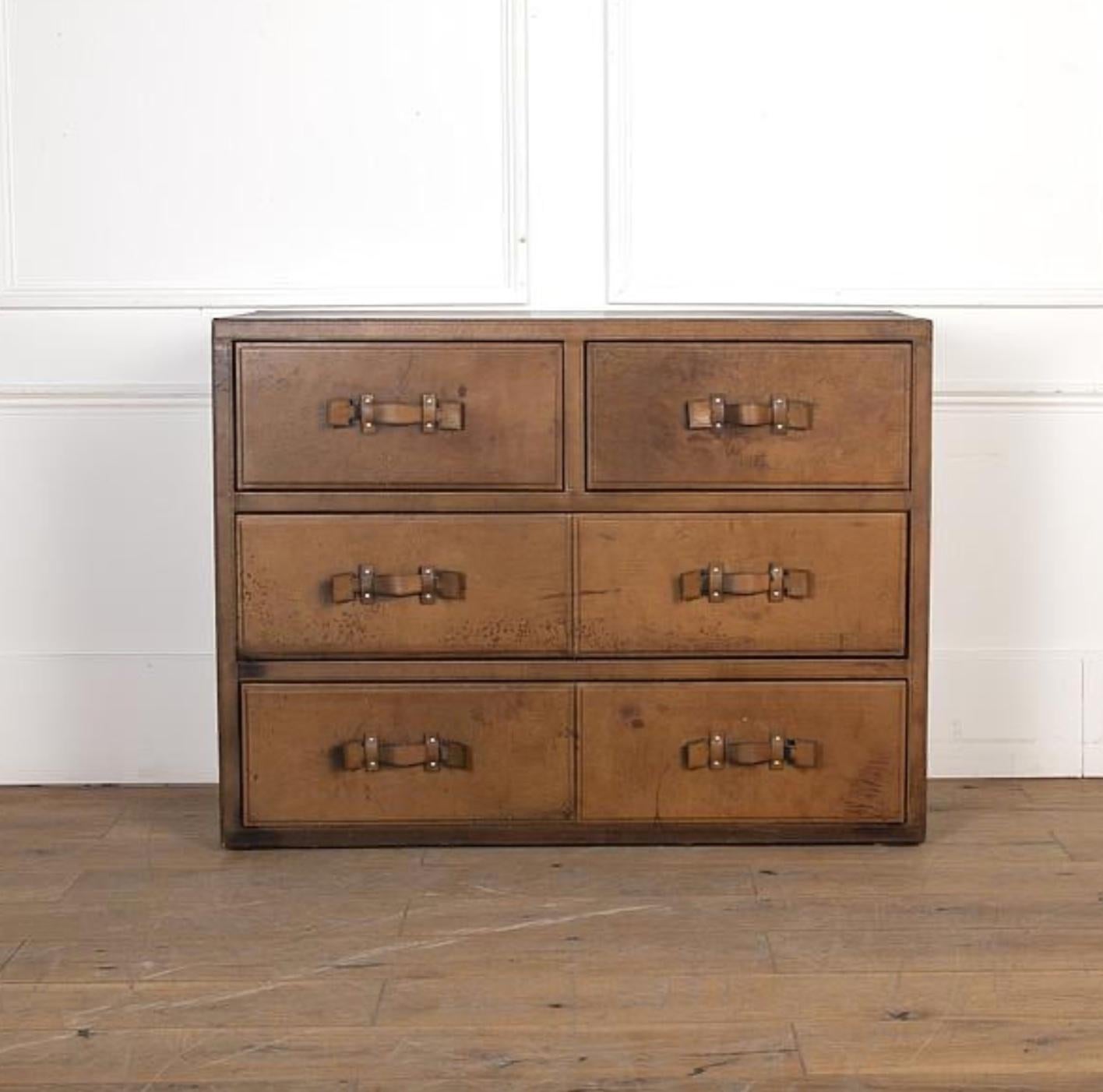 Leather covered chest of drawers from interwar England. Leather catch pull handles add great utilitarian flair. A handsome, understated piece with exceptional versatility. 

England, circa 1940

Dimensions: 36 H x 47 W x 18 D.
