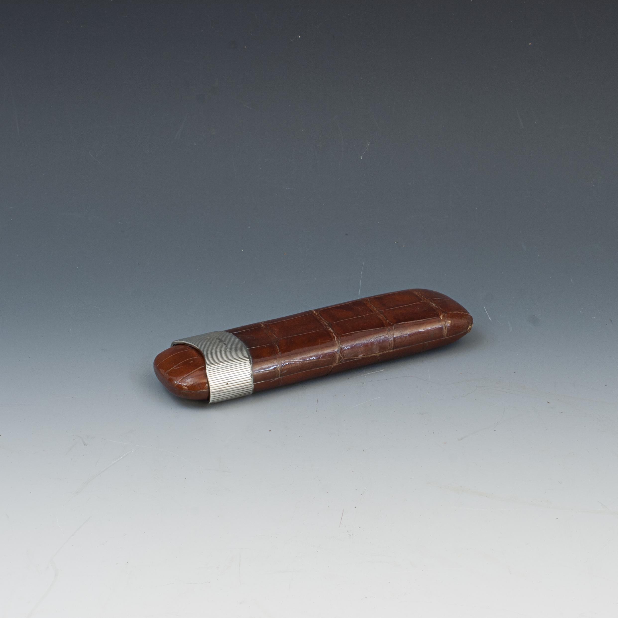 Antique Faux Crocodile Leather Cigar Case With Silver Collar.
A high quality faux crocodile leather Edwardian cigar case with thick fluted hallmarked silver collar, London 1910, makers mark unidentifiable. Embossed in gilt, a 'crown' and 'Katzau,
