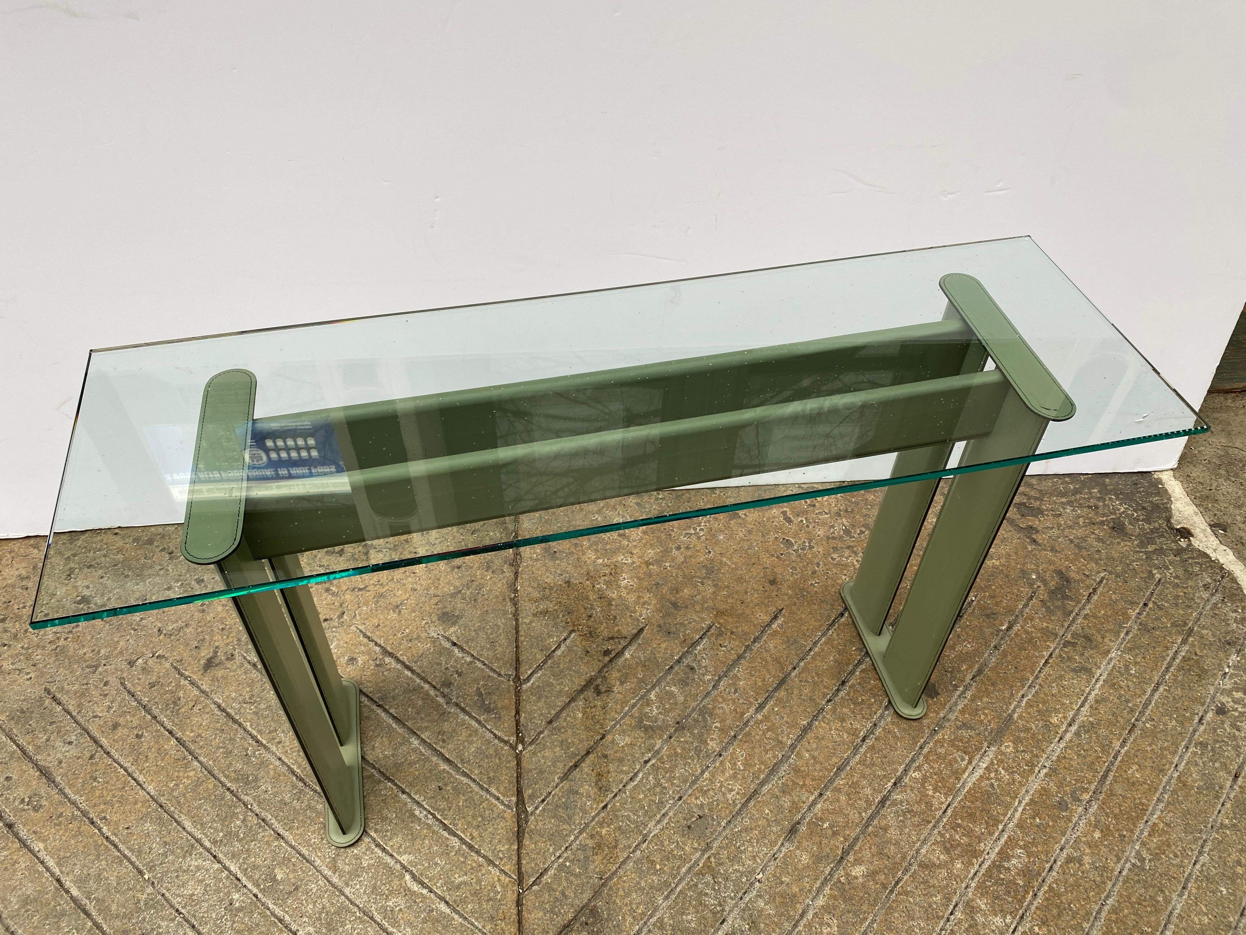 Leather Clad console with a new glass top. Designed by De Couro of Brazil. Dating to the late 1980's. Nice Condition with a simple Mario Bellini Aesthetic. Sage Green Leather with a Brand New Glass Top. Nice Scale, perfect behind a sofa or in an