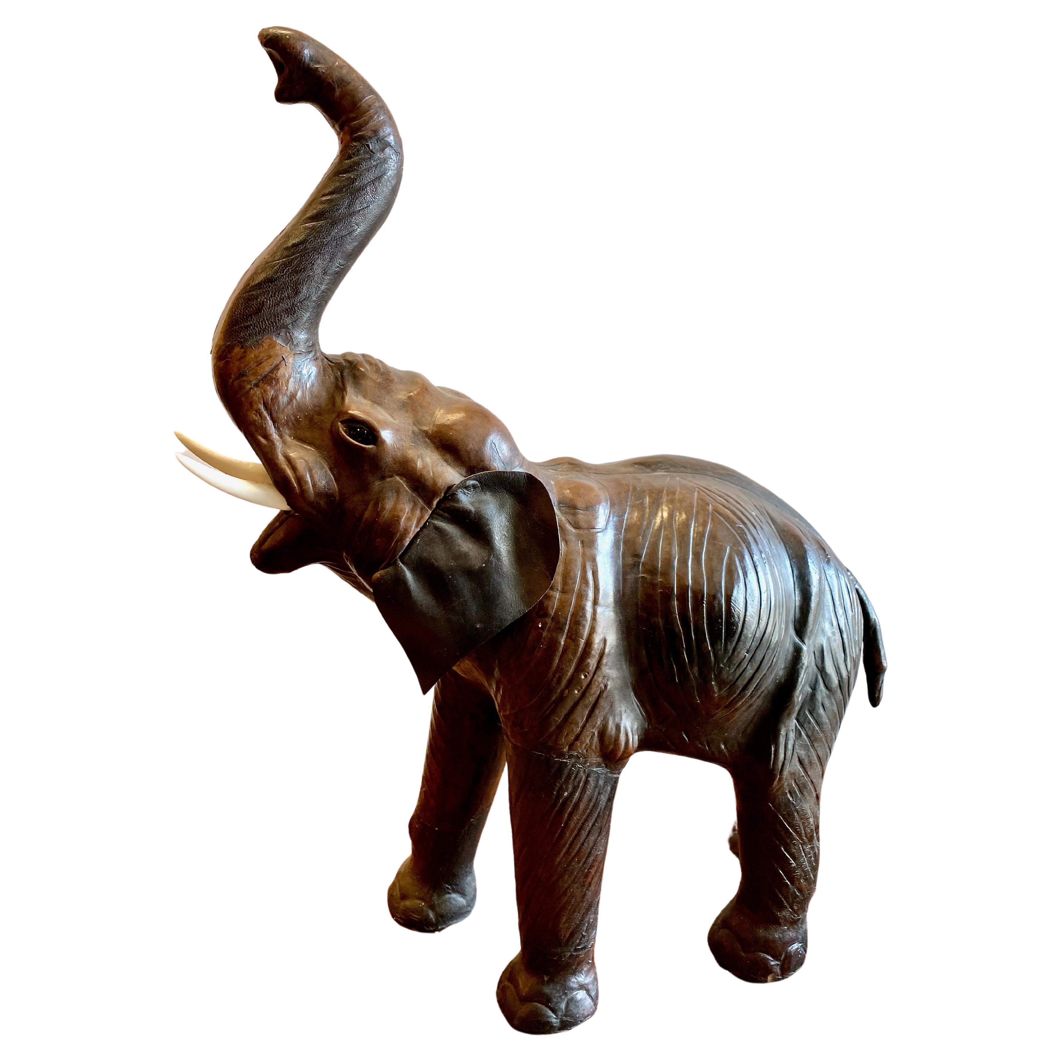 This a great example of a mid-20th century, circa 1950s, Elephant sculpture. The elephant has been eloquently detailed with all of his wondrous wrinkles and glass eyes. The leather ears are a bit stiff, but remain in good condition. The original