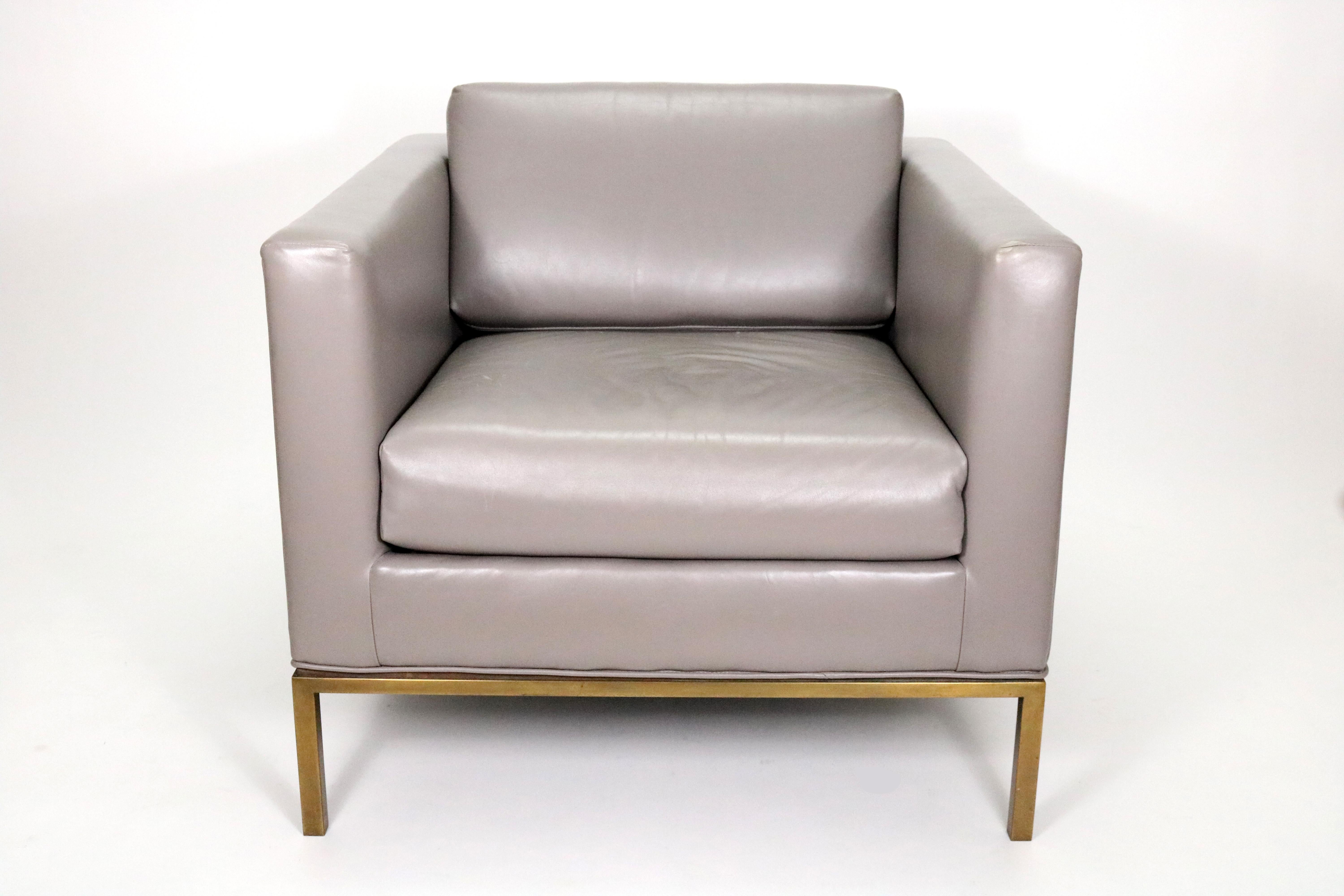 A handsome pale marine grey leather club chair on a gold chrome base. In the manner of Florence Knoll, California, Late 20th Century.

  