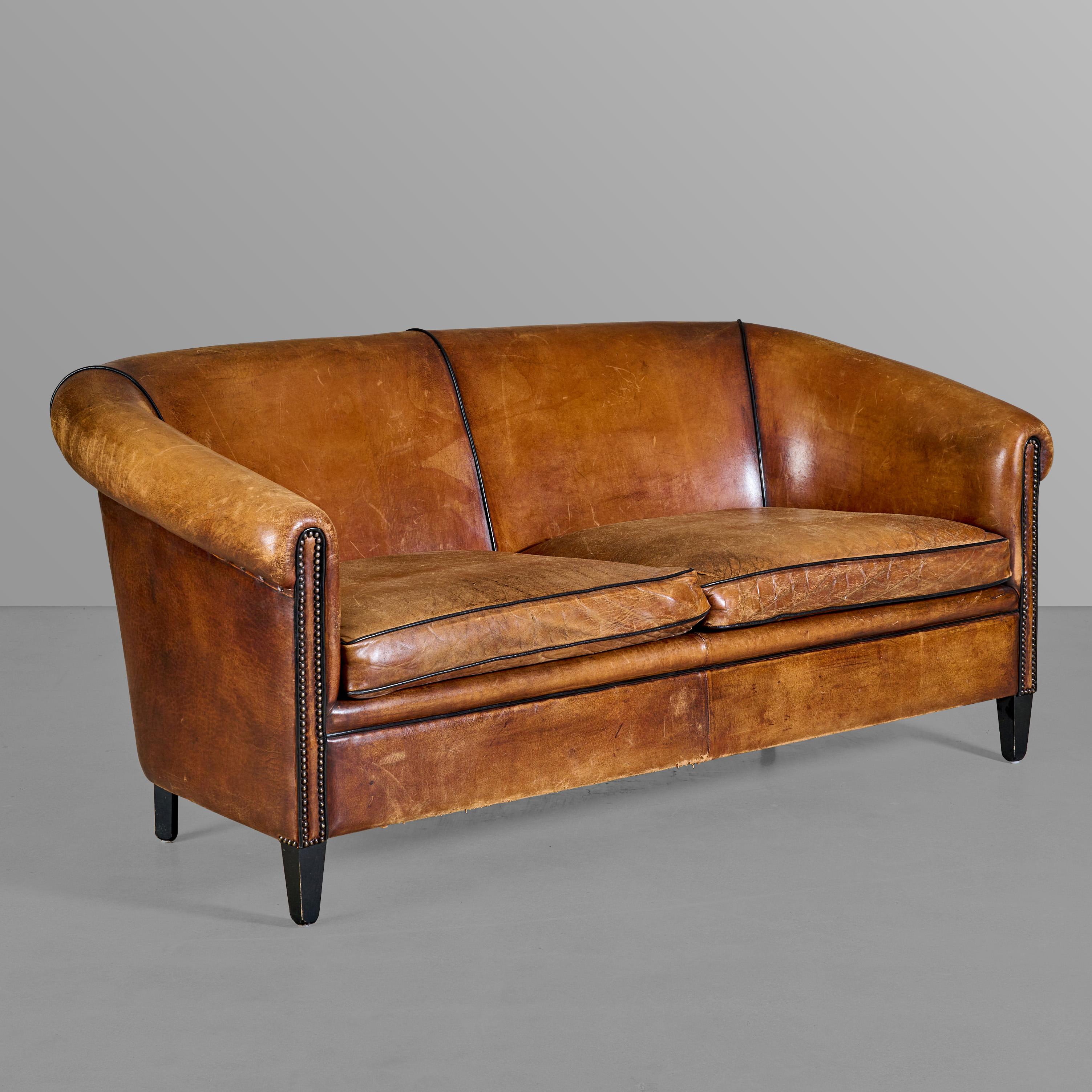 Leather club style sofa with nice trim and tack work.

