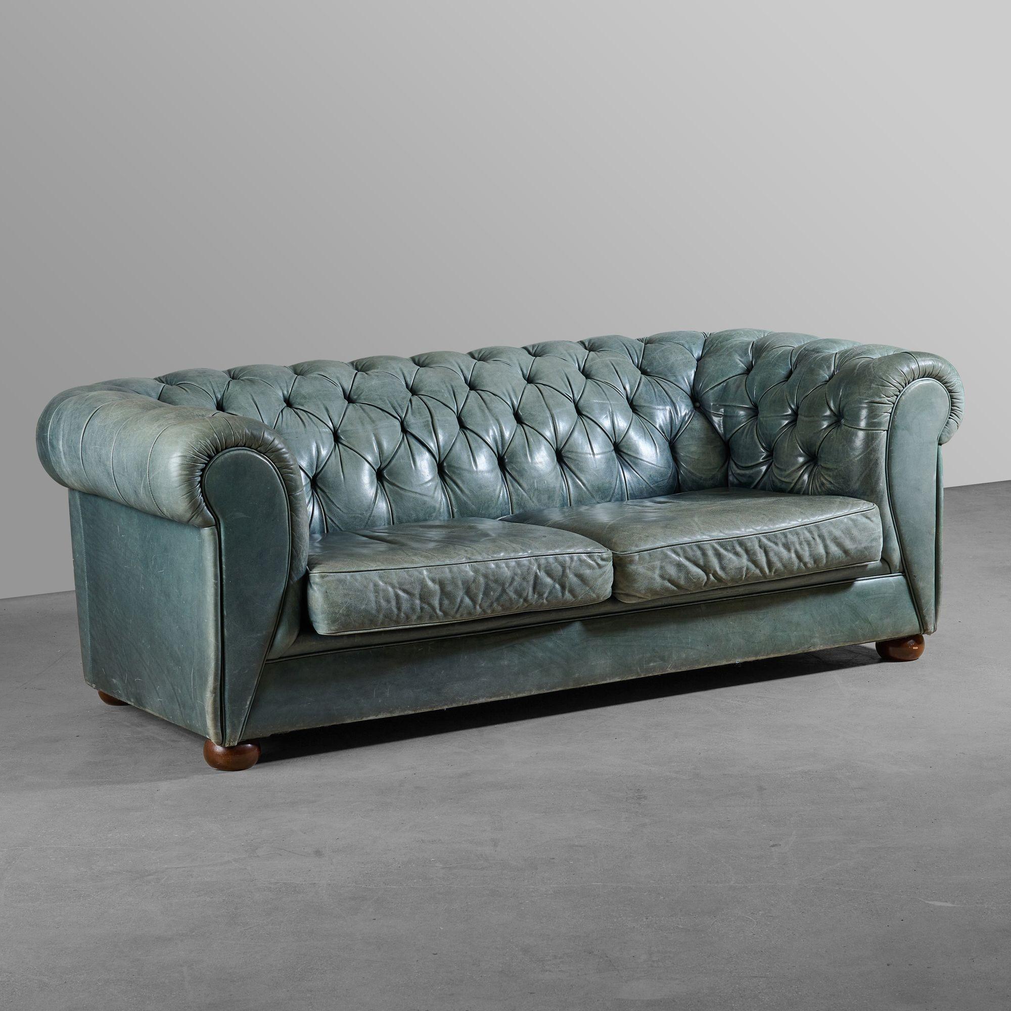 Green leather chesterfield sofa.