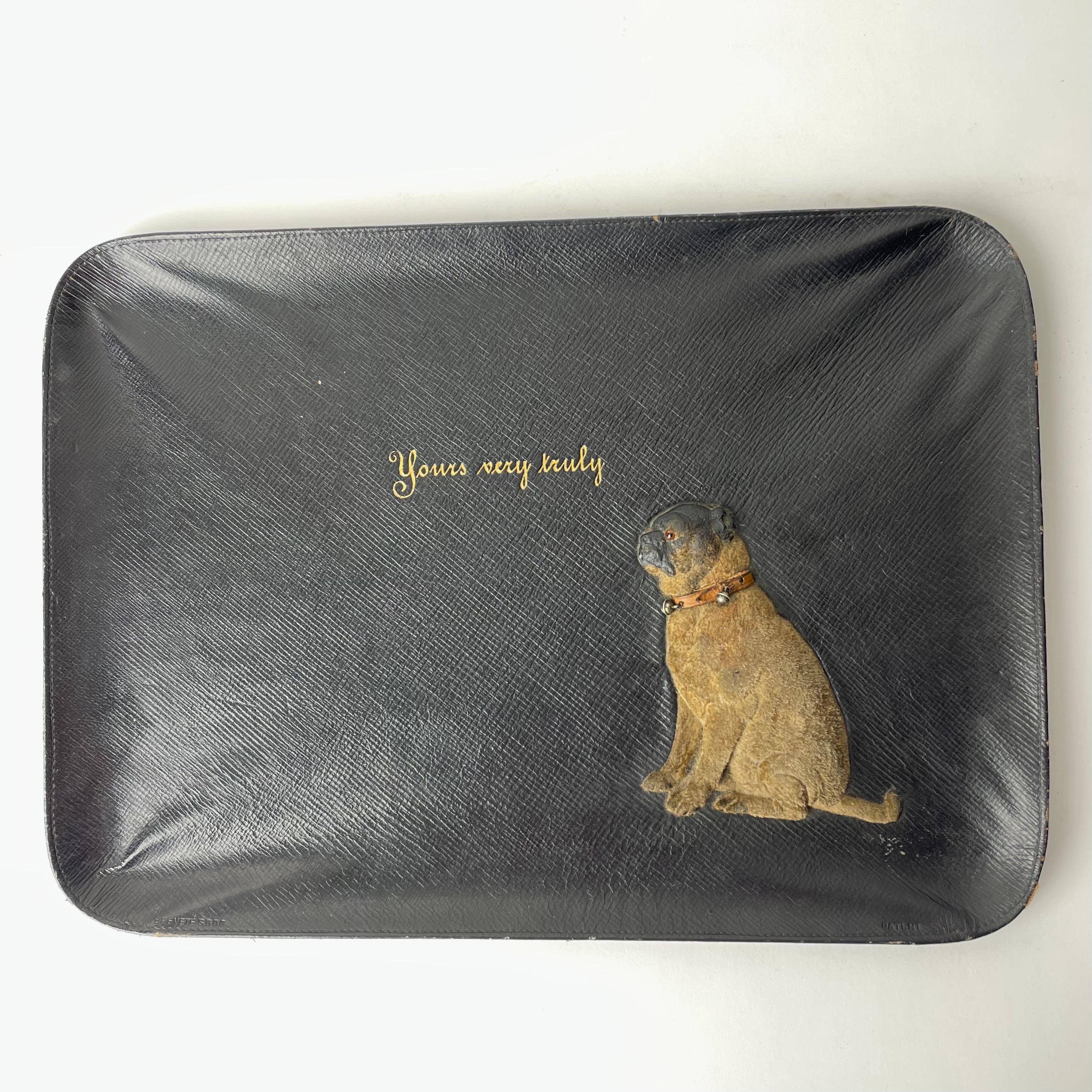 Leather-covered Desk Dish with charming dog from the early 20th Century. Made in Austria by J. Weidman K.K. Hoffabrikant in Wienna. The charming dog with bells in the collar.

Wear consistent with age and use. See photos.