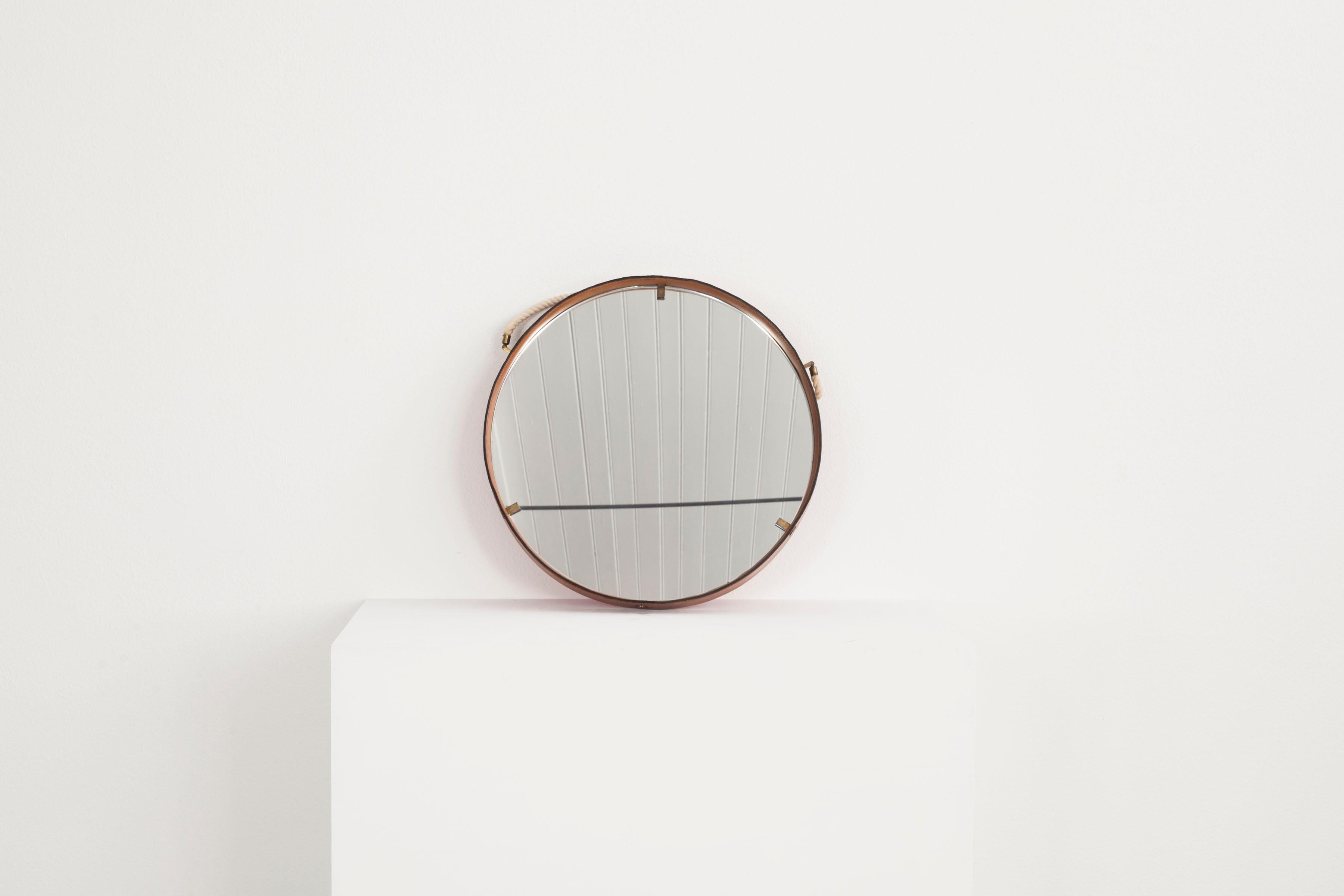 Mid-Century Modern  Leather-covered round wall mirror with brass elements, Italy 1960s. For Sale