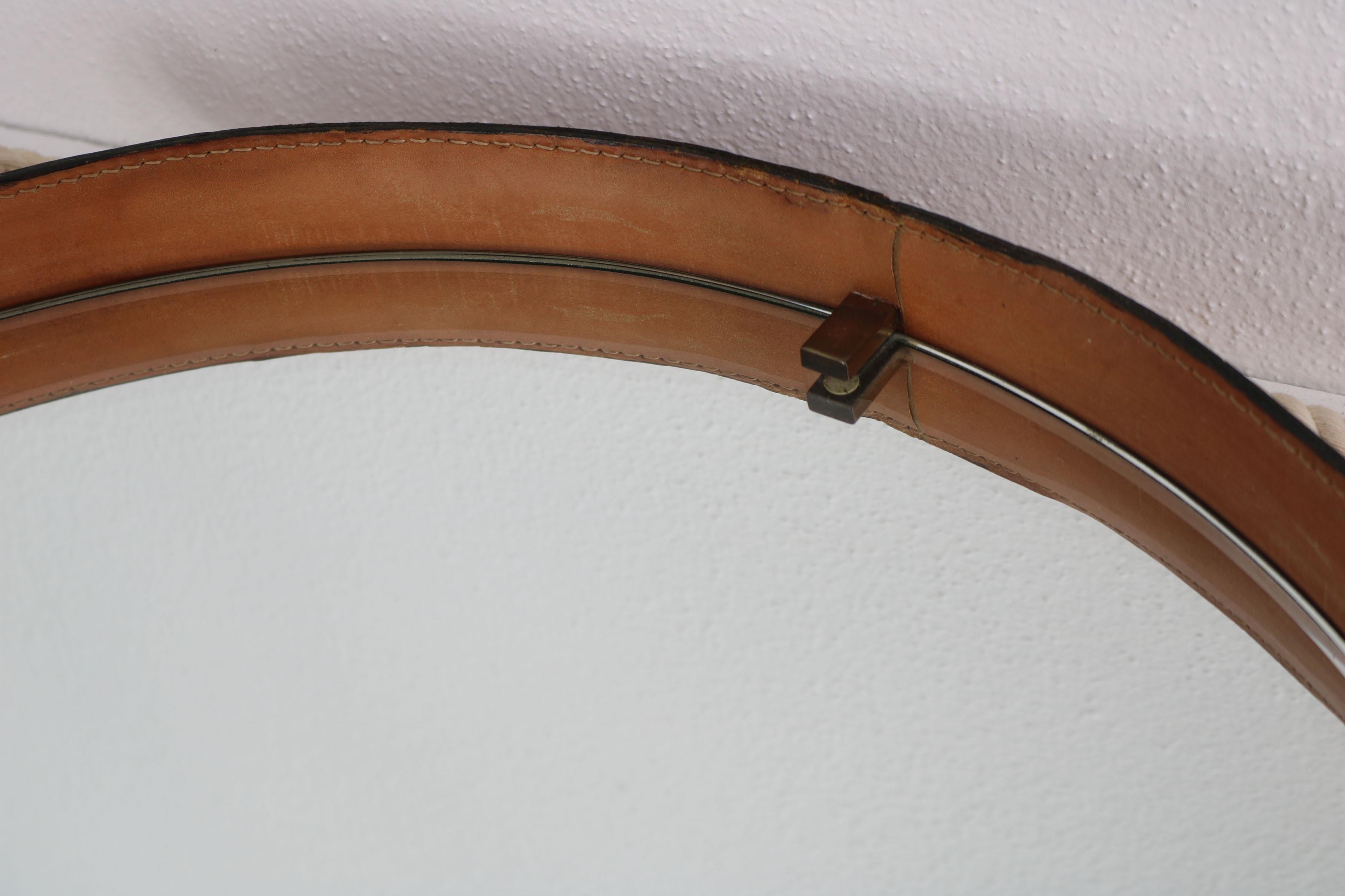 Mid-20th Century  Leather-covered round wall mirror with brass elements, Italy 1960s. For Sale