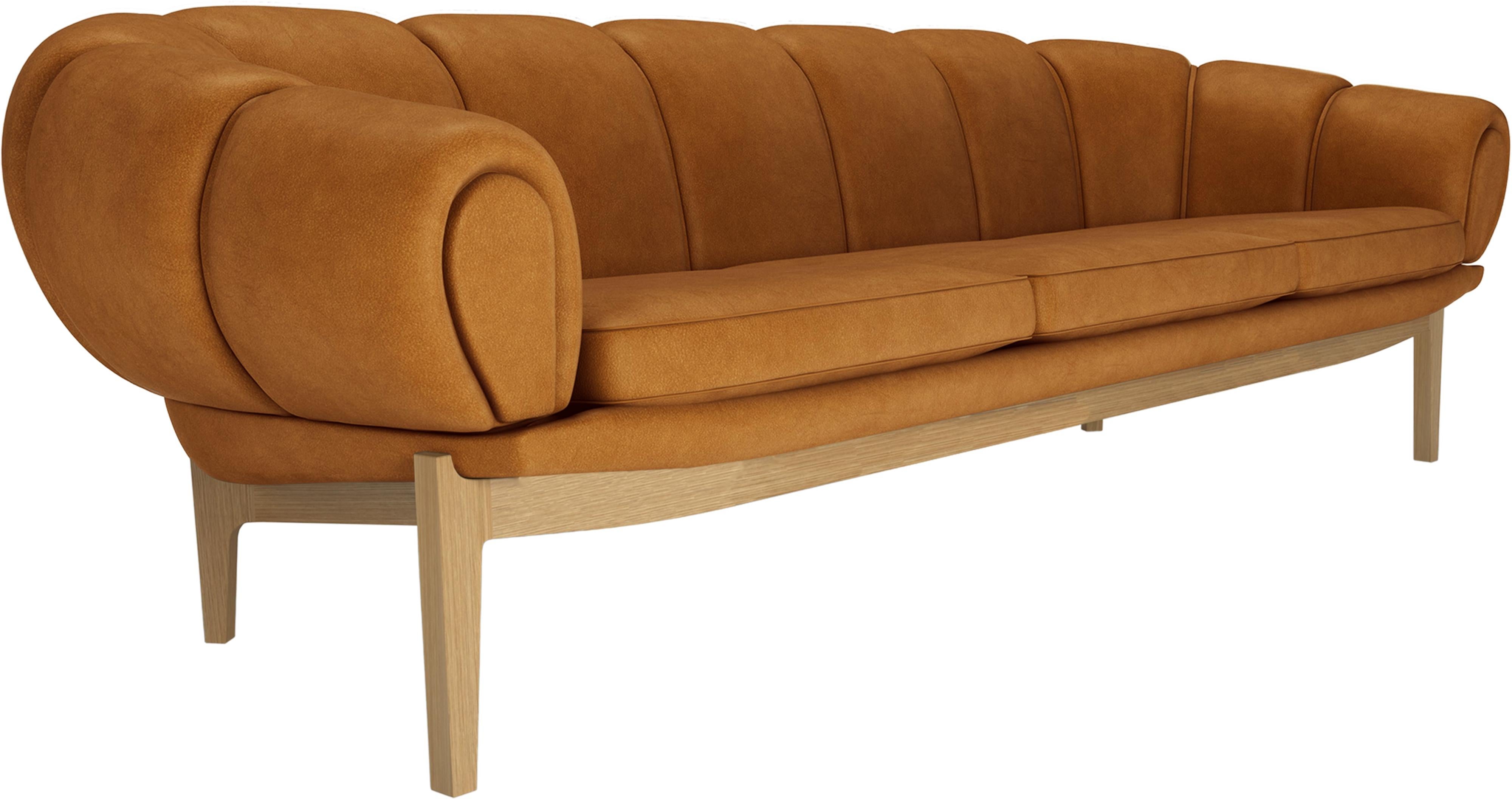 Leather 'Croissant' sofa by Illum Wikkelsø for Gubi with oak Legs.

Playful, voluptuous and expertly crafted, the newly reimagined Croissant collection from Gubi makes a powerful statement in any interior setting and an heirloom to treasure for
