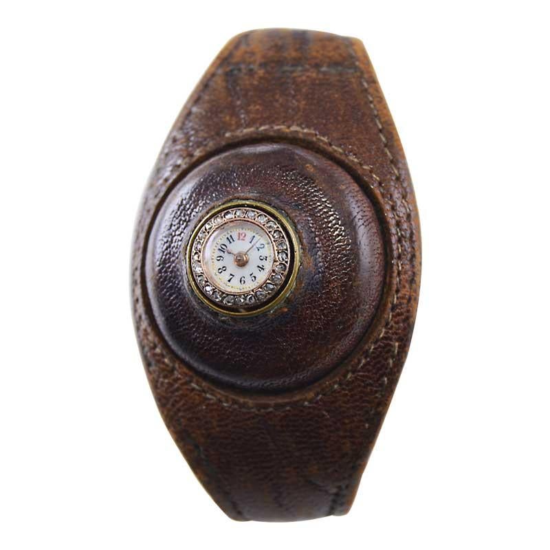 FACTORY / HOUSE: Leather Cuff Watch
STYLE / REFERENCE: Custom Made
METAL / MATERIAL: 18Kt. Yellow Gold
CIRCA / YEAR: 1900's
DIMENSIONS / SIZE: Length 23mm X Diameter 10mm
MOVEMENT / CALIBER: Manual Winding / 10 Jewels / Cylindrical Escapement /